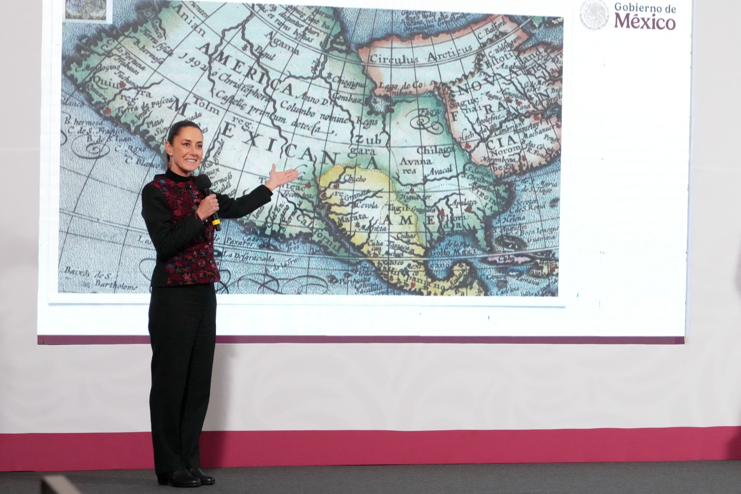 Mexico's President Claudia Sheinbaum shows a world map.