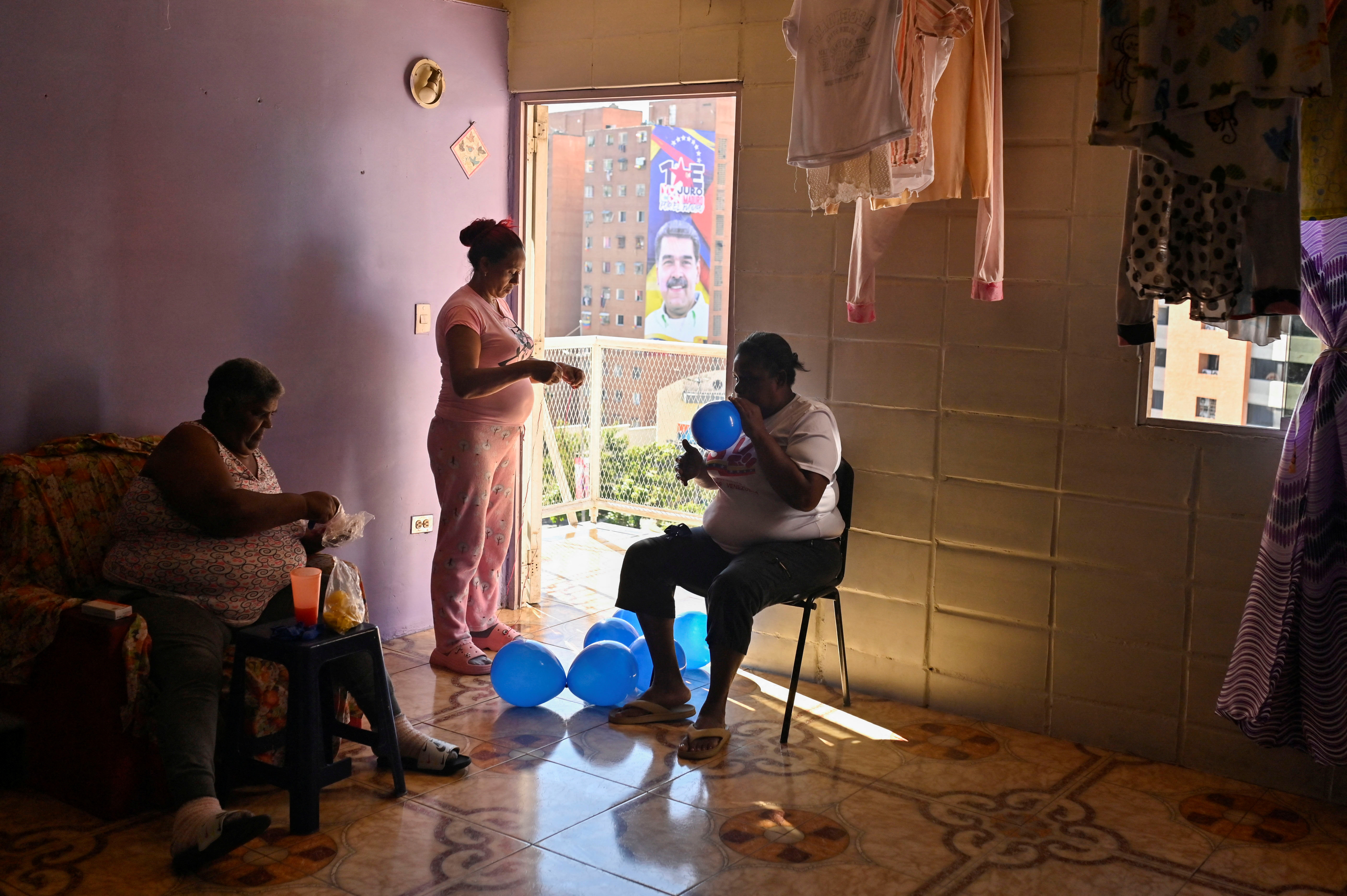 Supporters of Venezuela's President Nicolas Maduro decorate an apartment with balloons on the day of Maduro's inauguration for a third six-year term, in Caracas, Venezuela January 10