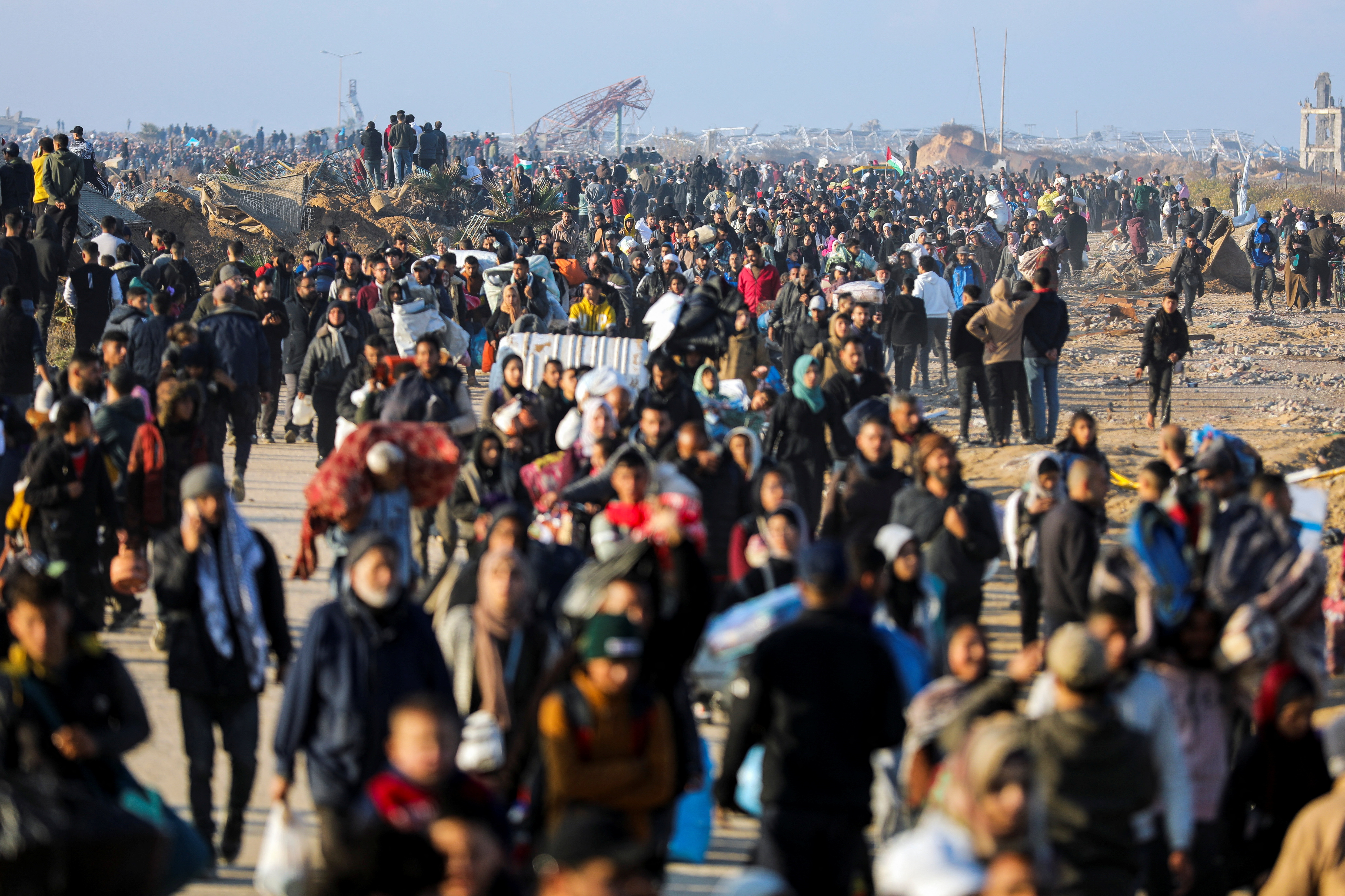 People walk back to their homes in northern Gaza