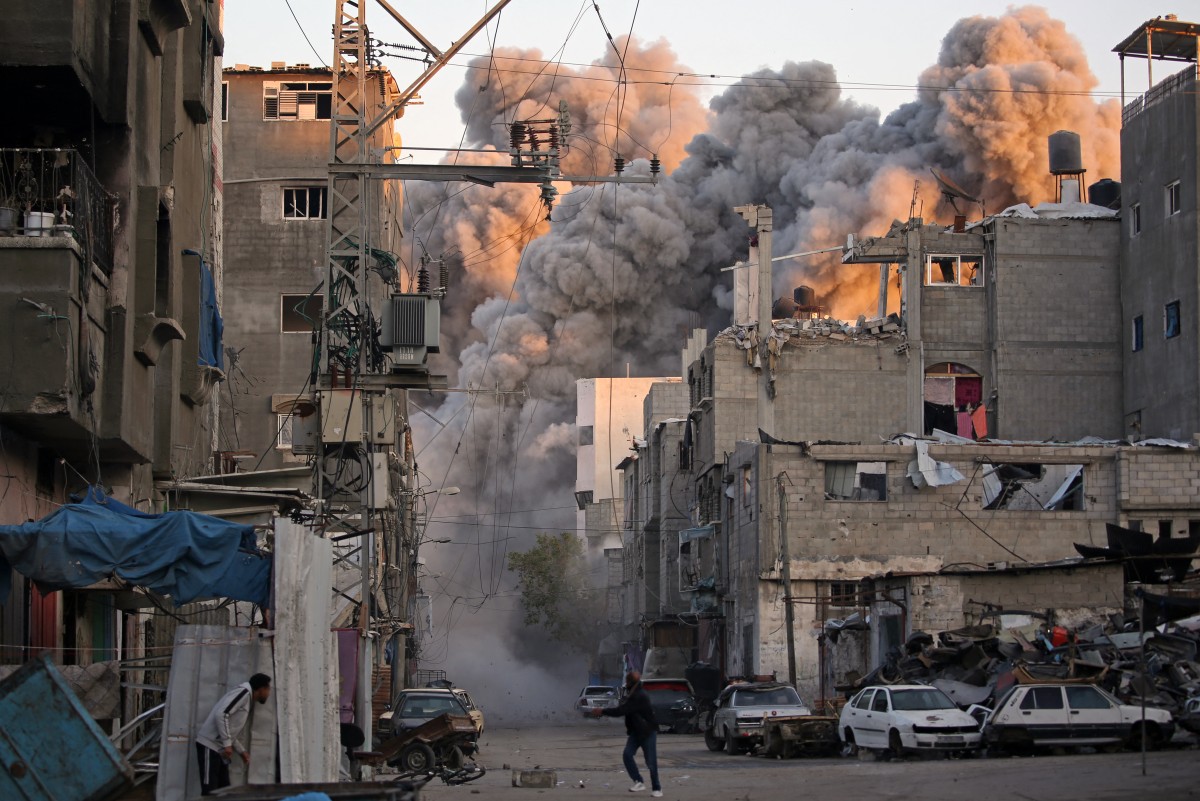 Smoke rises from a building destroyed in an Israeli air strike.