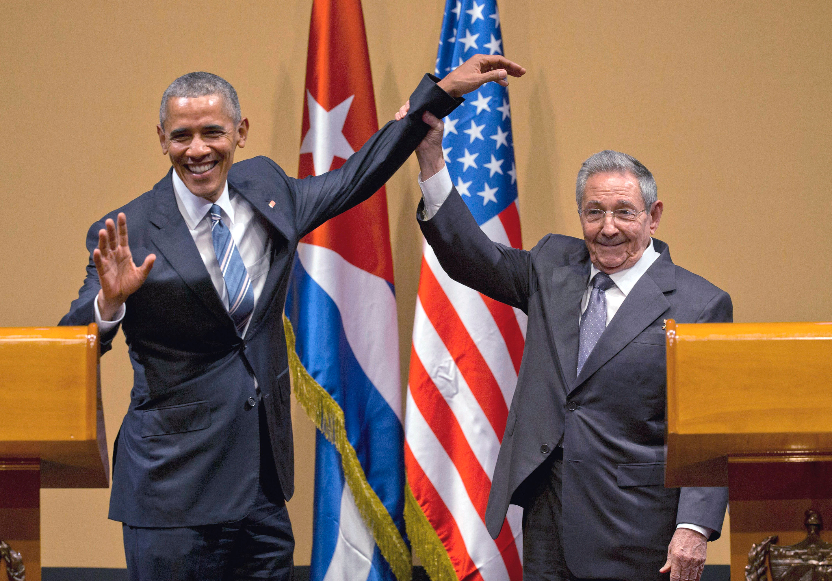 Barack Obama poses with Raul Castro