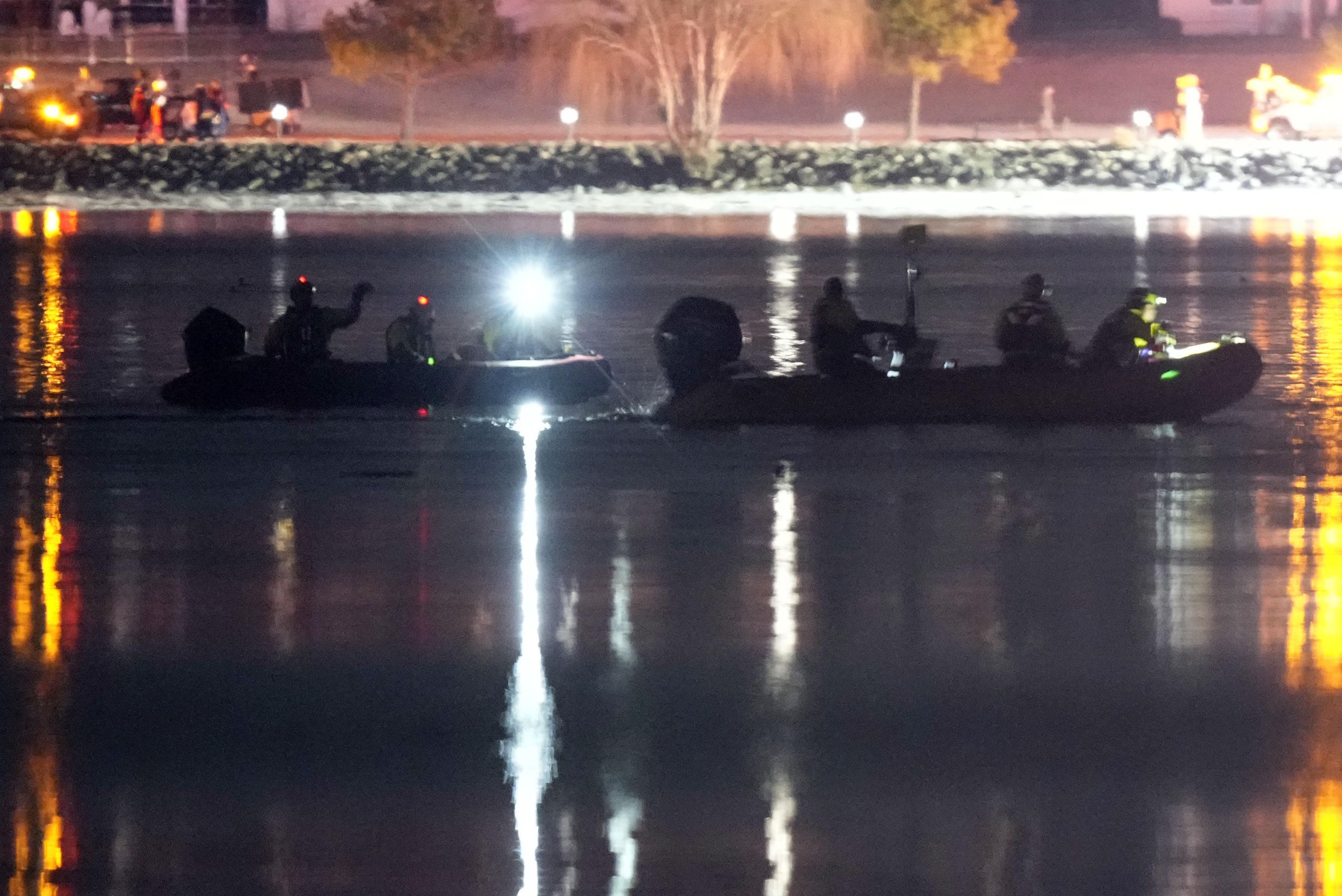 Boats work the scene in the Potomac River near Reagan Washington national airport