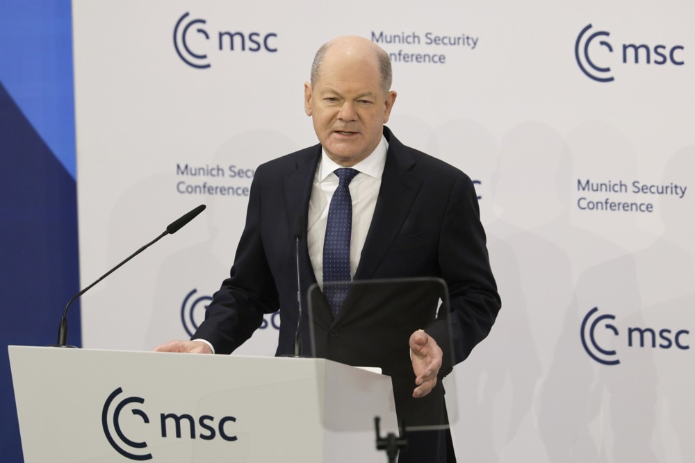 German Chancellor Olaf Scholz speaks at a podium.