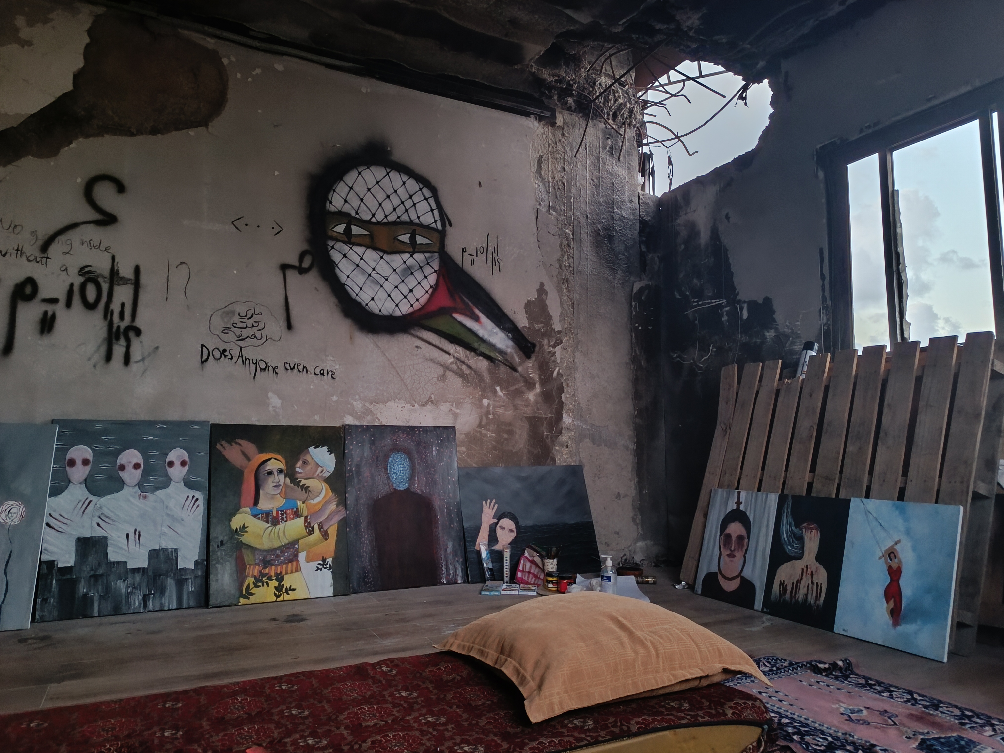 Ibrahim Mohana’s makeshift studio stands amid the ruins of his home, partially destroyed by an Israeli tank shell.