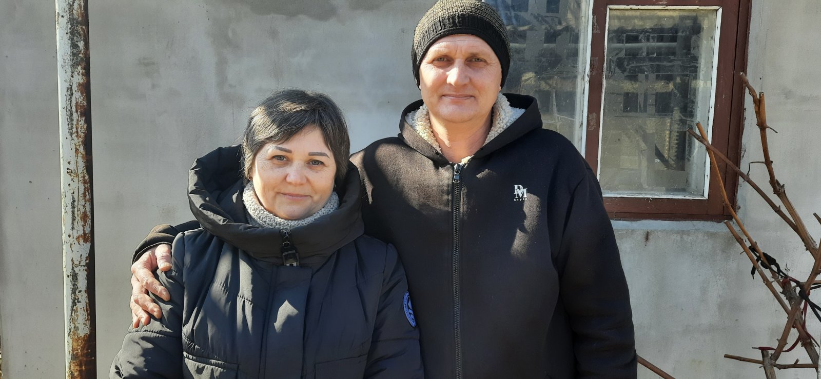 Olha, pictured with her husband Dmytro, in front of their house in Voznesensk [Courtesy of Olha’s family]