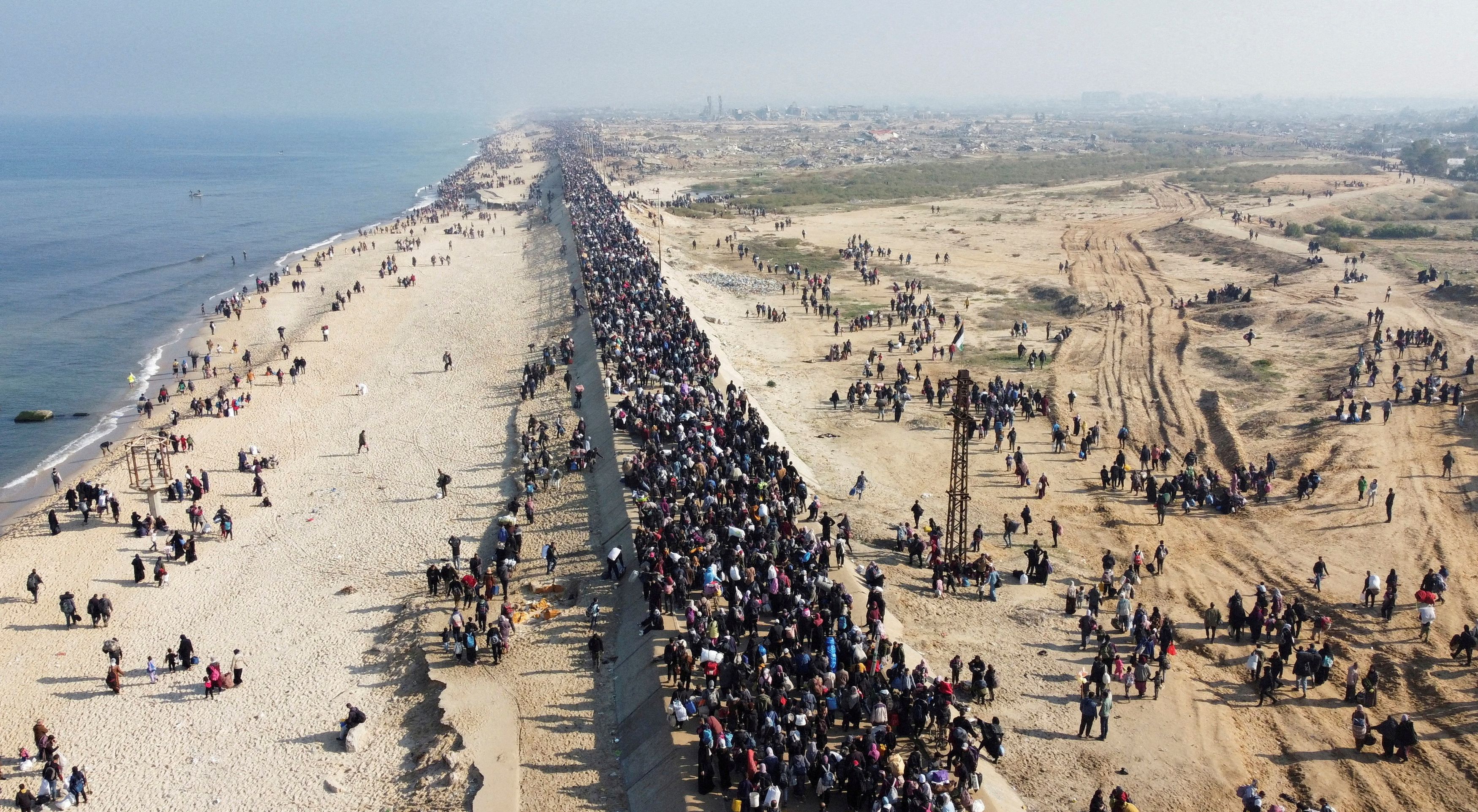 A drone view shows Palestinians, who were forcibly displaced to the south of the Gaza Strip by the Israeli army, making their way back to their homes in the north in January 2025