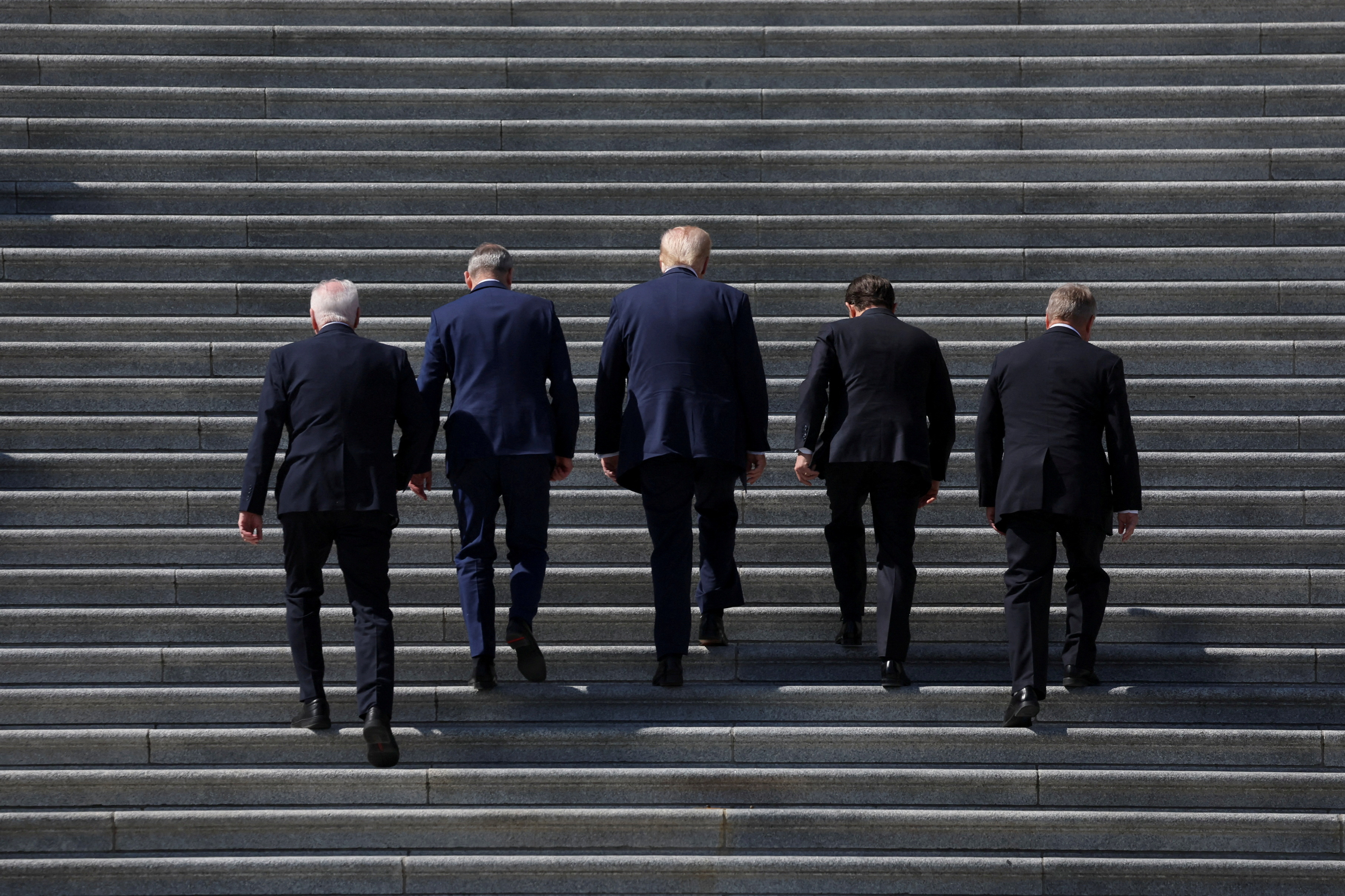 President Donald Trump, House Speaker Mike Johnson and Irish Taoiseach Micheal Martin climb the US Capitol steps
