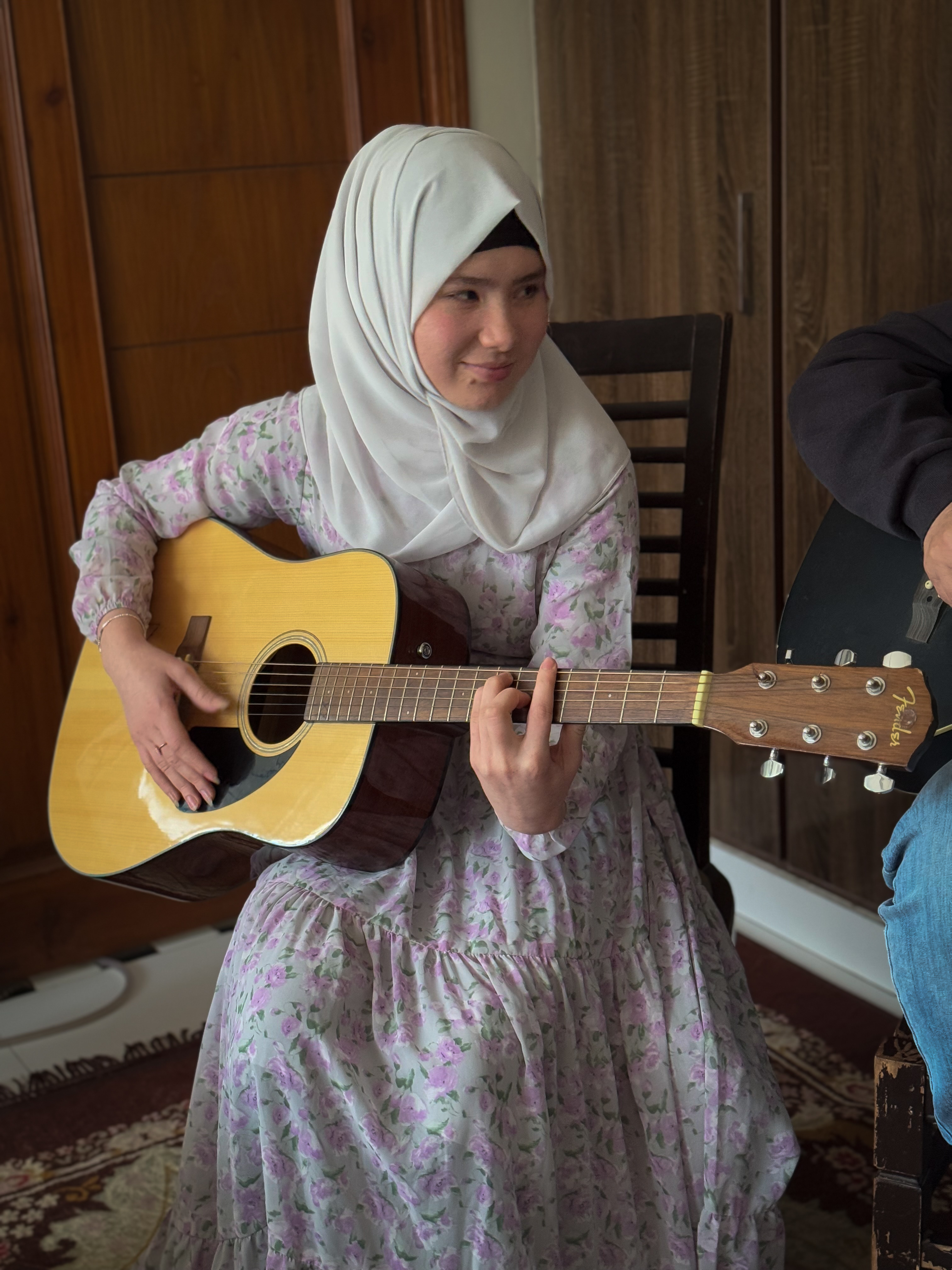 Zakia, 16, from Kabul, plays her guitar while practising in Islamabad, Pakistan on February 14, 2025