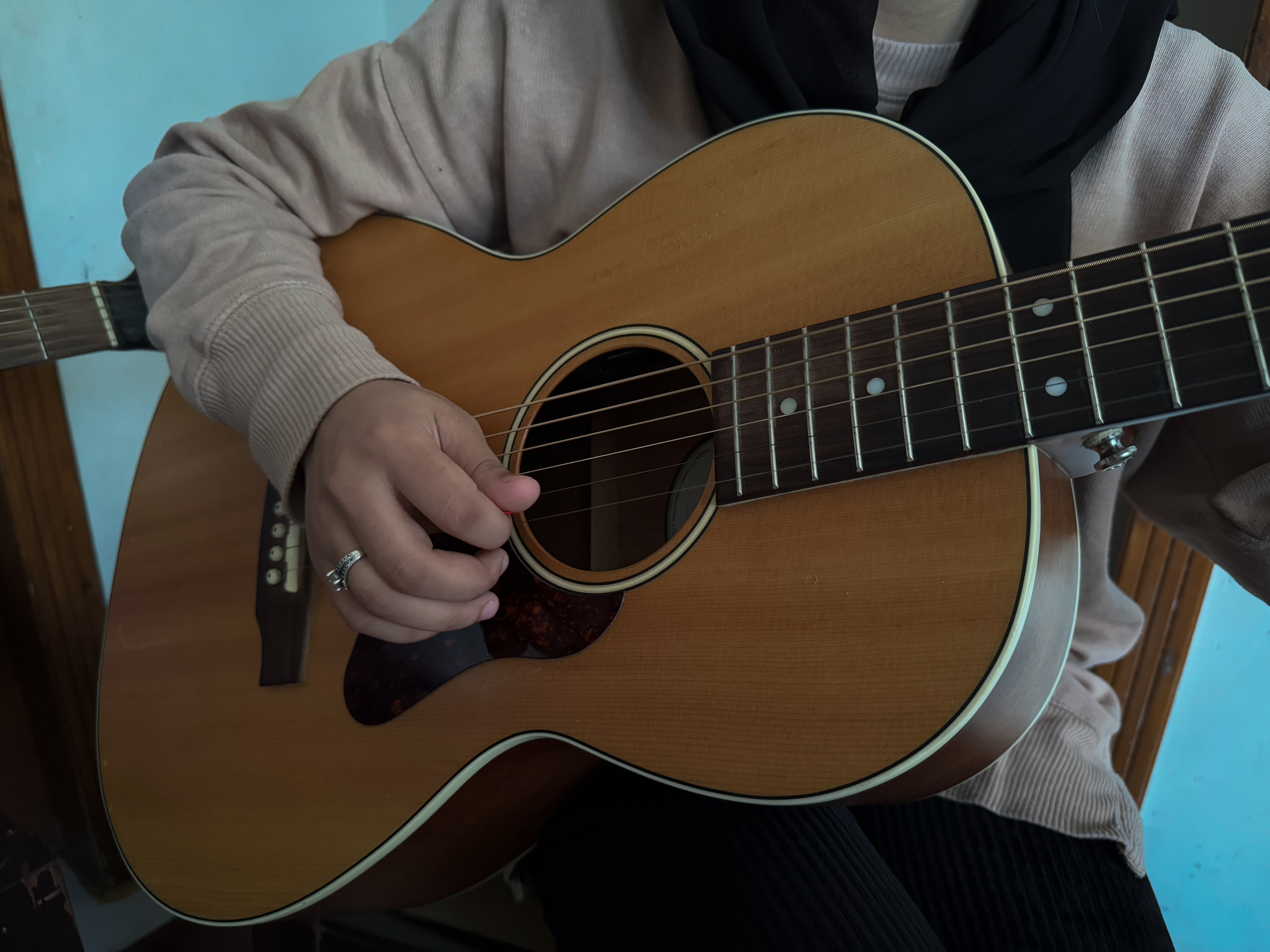 Yasemin plays the guitar at her home in Islamabad, Pakistan