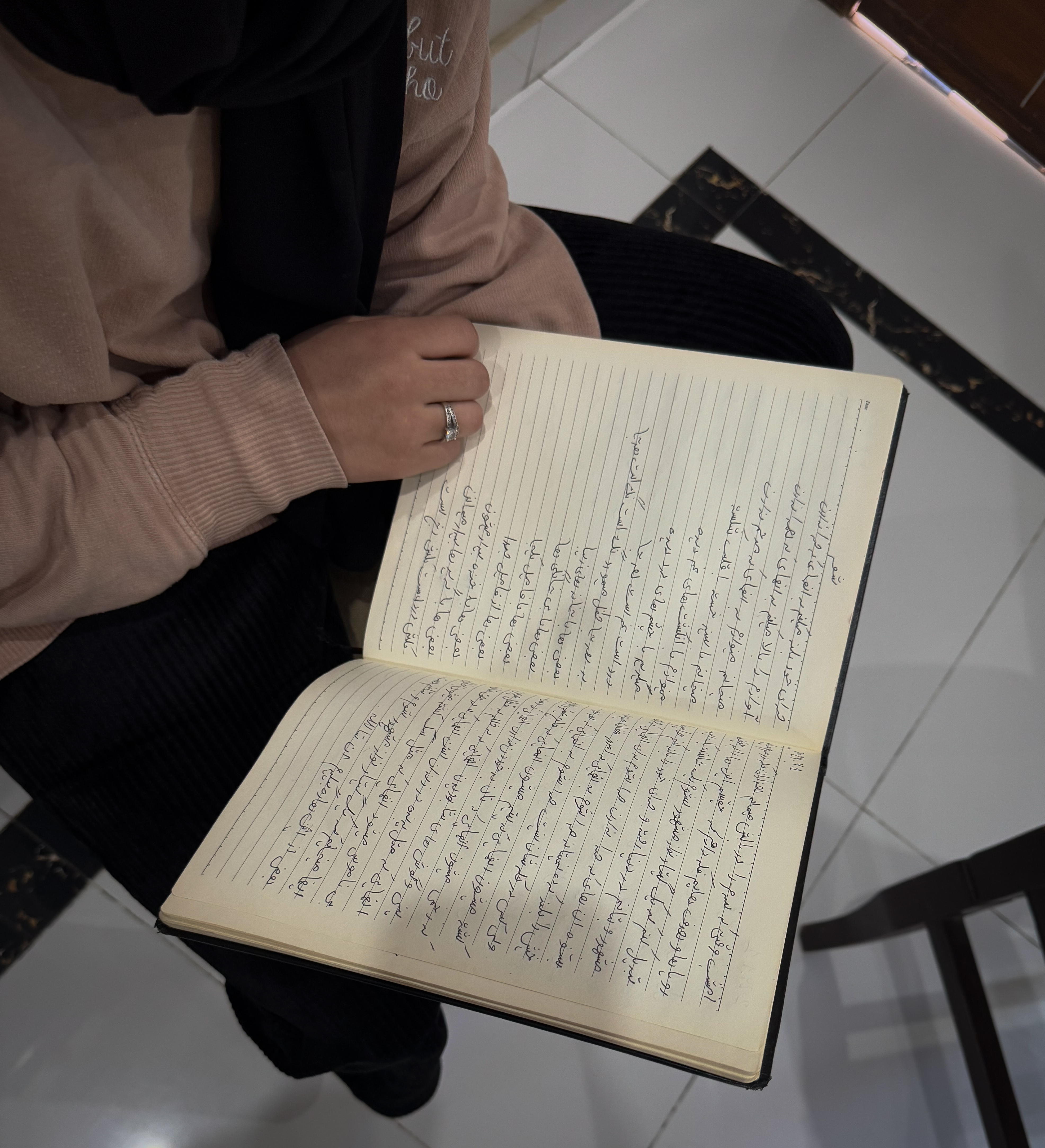 Yasemin reads from her diary of songs in the Dari language at her home in Islamabad, Pakistan