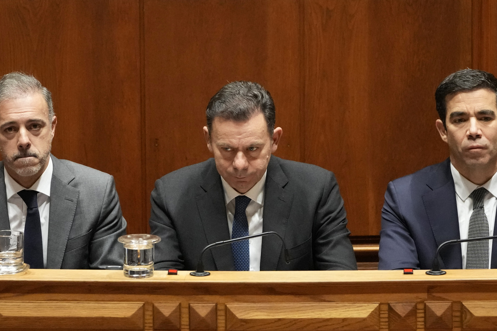 a man in a suit looks down looking disappointed in a wooden chamber