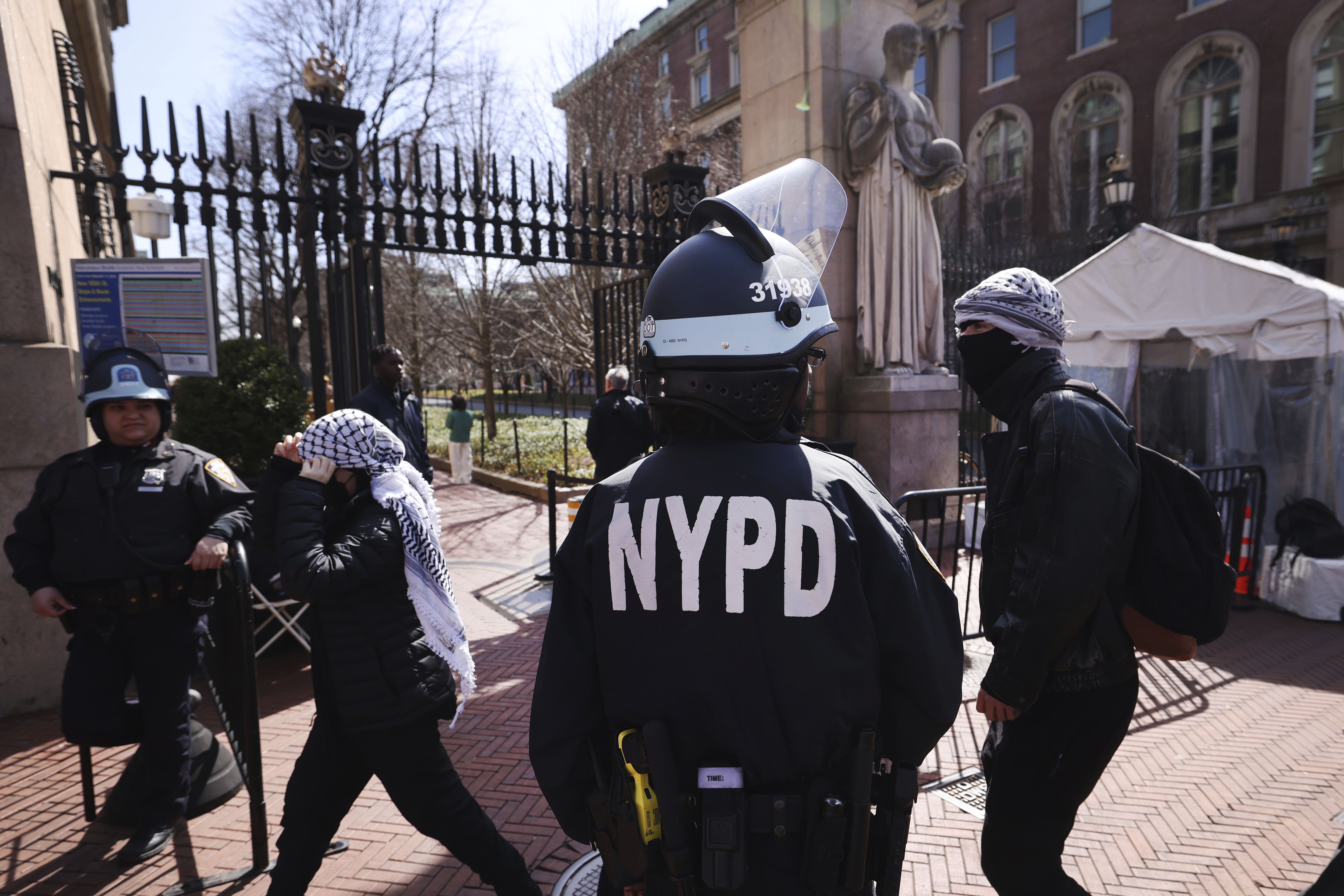 Police guard the entrance to Columbia University as protesters rally in support of detained Palestinian activist Mahmoud Khalil, Friday, March 14, 2025, in New York. (AP Photo/Jason DeCrow)