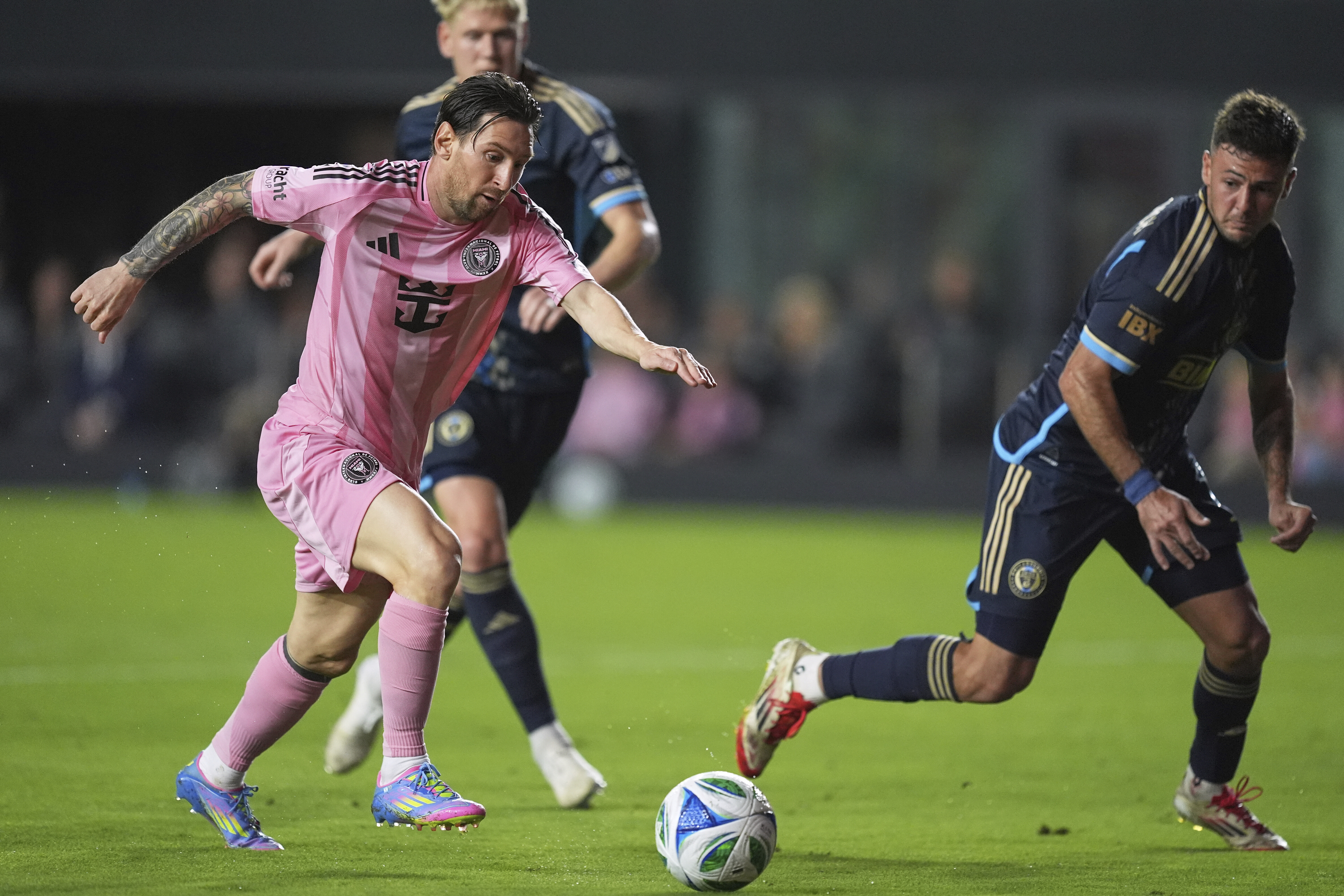 Inter Miami forward Lionel Messi, left, runs to score his side’s second goal past Philadelphia Union defender Ian Glavinovich during the second half of their MLS match on March 29, 2025, in Fort Lauderdale, Florida, US