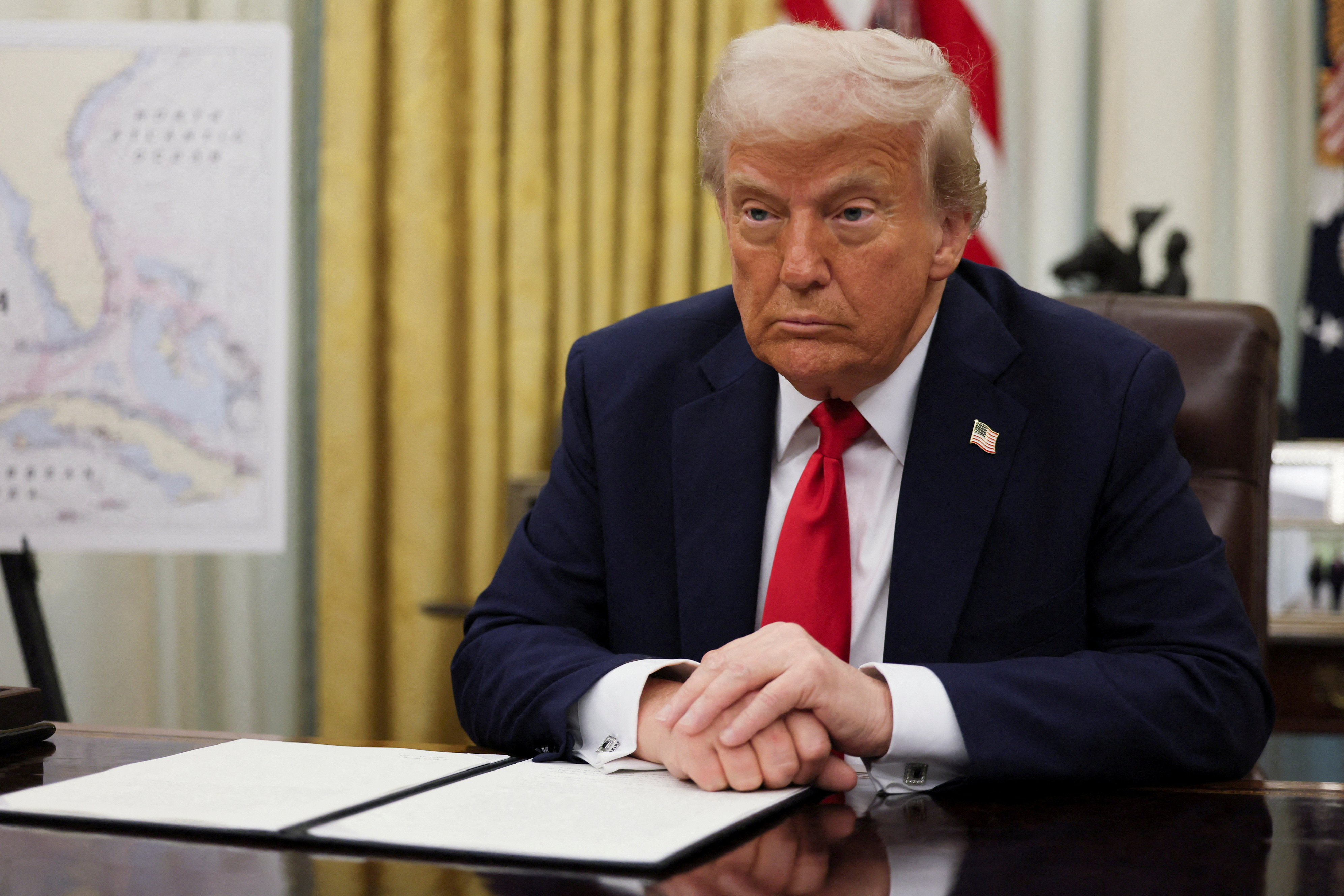 U.S. President Donald Trump signs an executive order in the Oval Office, in Washington