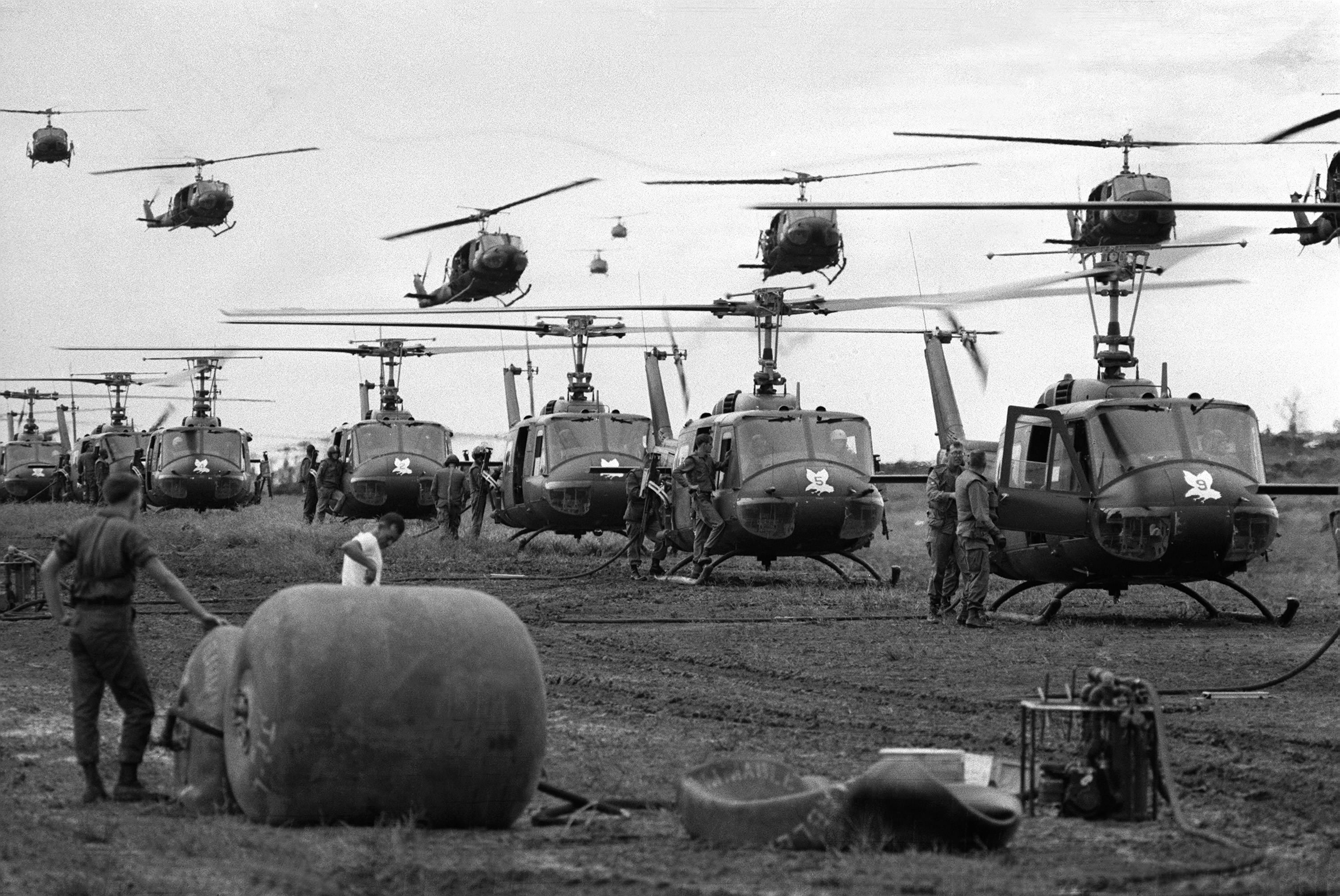 U.S. Huey helicopters fly in formation over a landing zone in South Vietnam during the Vietnam War, date unknown. (AP Photo)