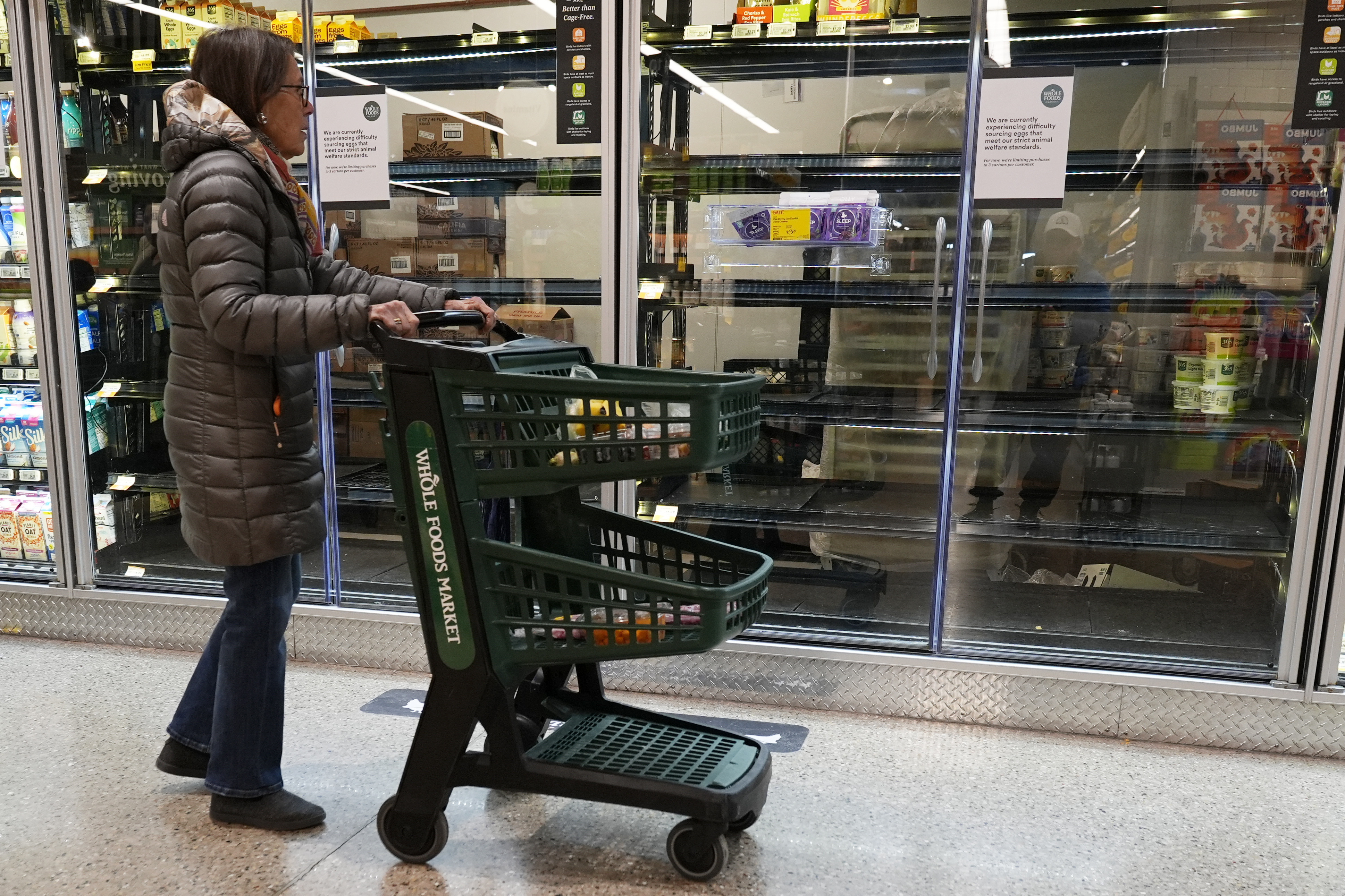 A shopper checks an information sign about eggs and empty shelves at a grocery store in Vernon Hills, Ill., Feb. 9, 2025. (AP Photo/Nam Y. Huh, File)