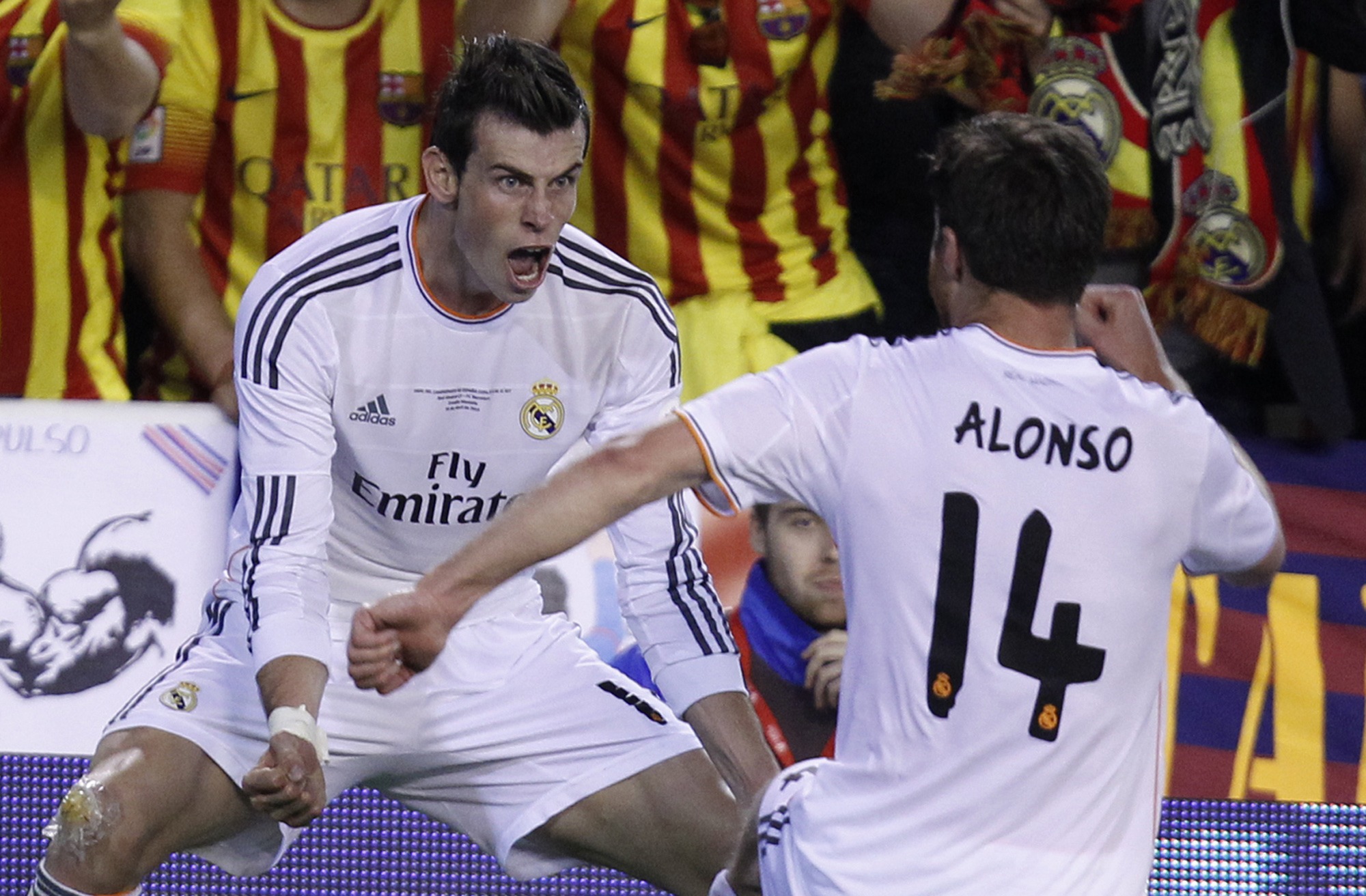 Real’s Gareth Bale, left, celebrates with Xabi Alonso after scoring his team’s second goal during the final of the Copa del Rey against Barcelona in Valencia on April 16, 2014