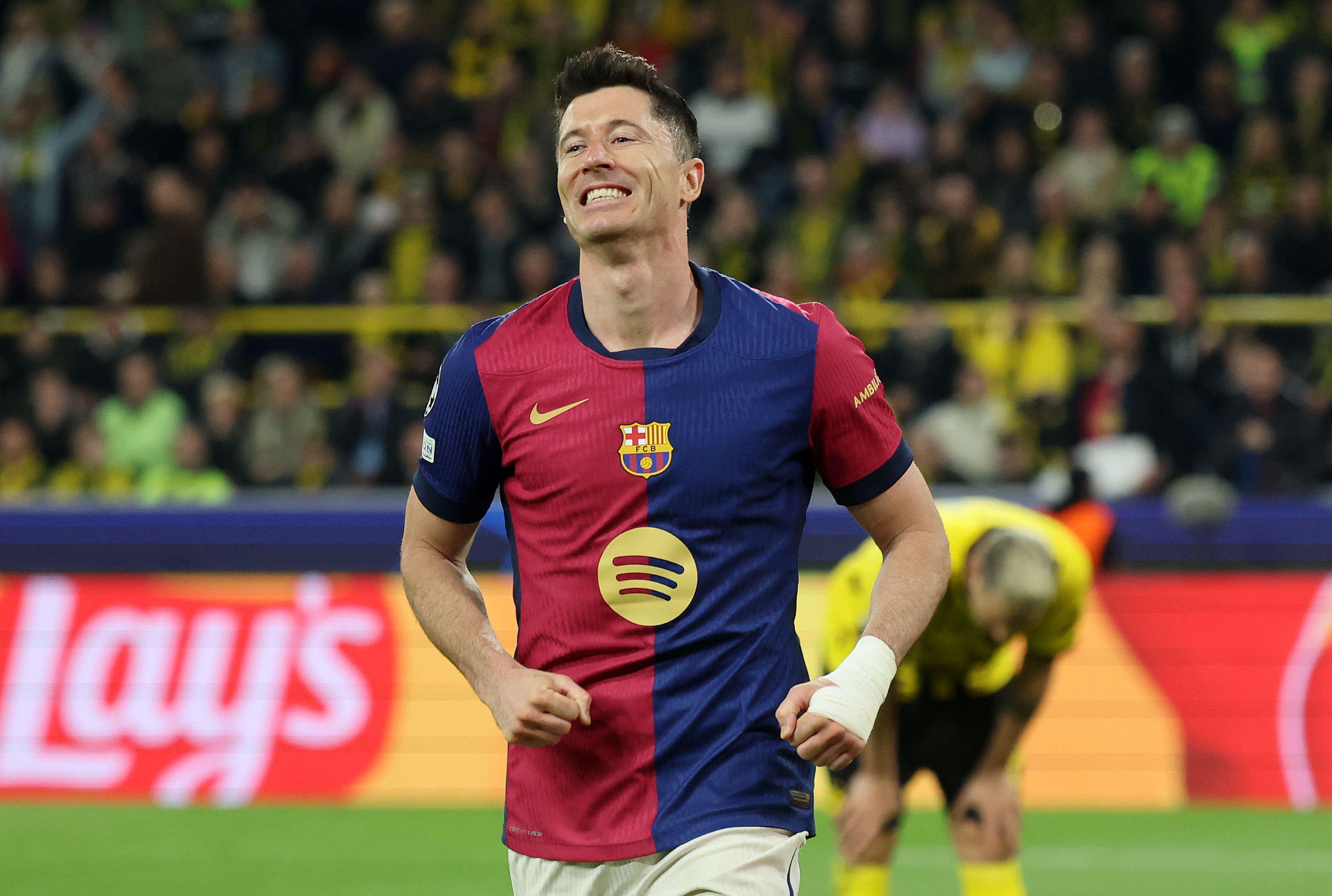 DORTMUND, GERMANY - APRIL 15: Robert Lewandowski of FC Barcelona celebrates after Ramy Bensebaini of Borussia Dortmund concedes an own goal, resulting in the first goal for FC Barcelona, during the UEFA Champions League 2024/25 Quarter Final Second Leg match between Borussia Dortmund and FC Barcelona at BVB Stadion Dortmund on April 15, 2025 in Dortmund, Germany. (Photo by Alex Grimm/Getty Images)