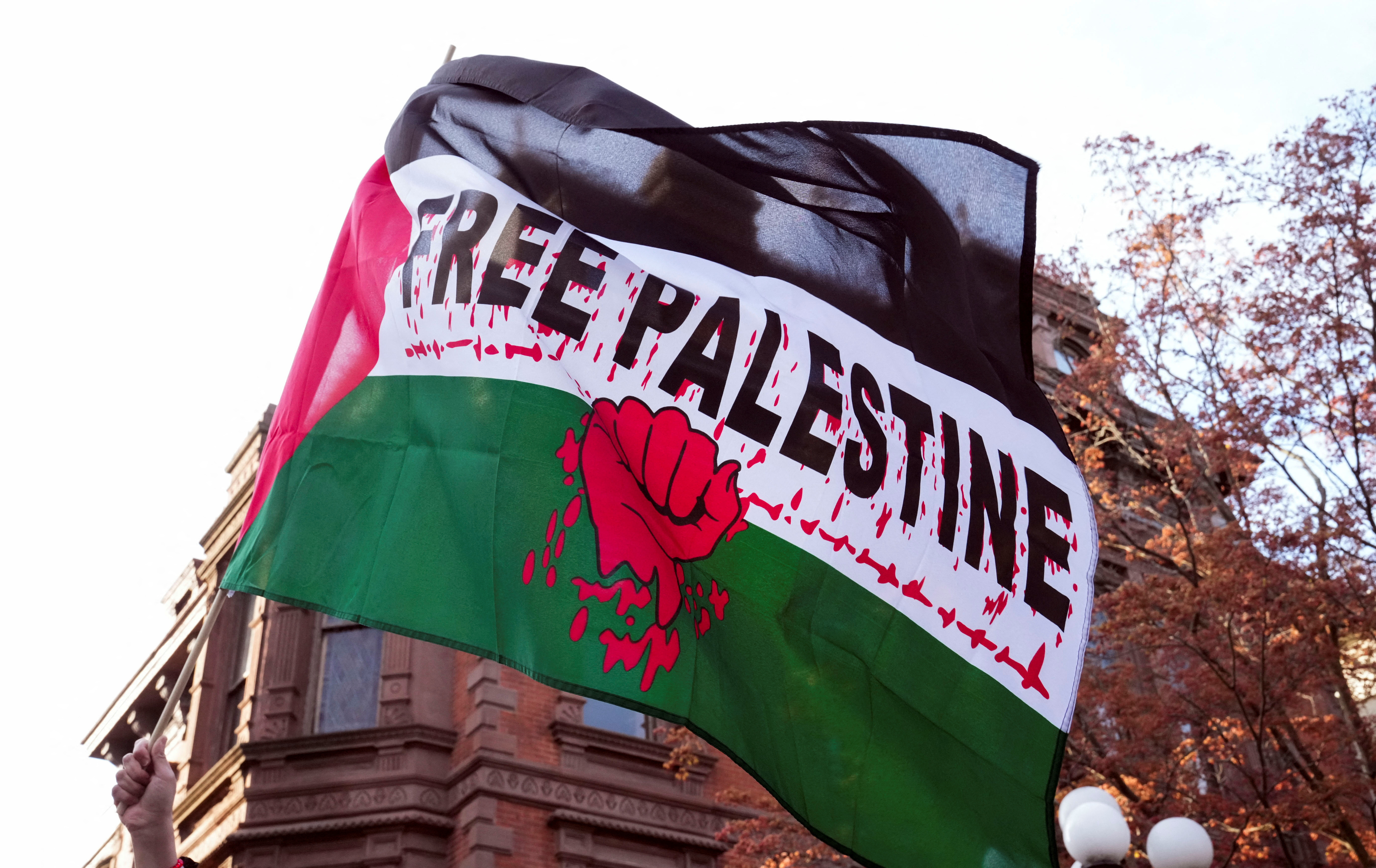 A person holds a flag that says "Free Palestine" during a protest against a planned speech by Israel's National Security Minister Itamar Ben-Gvir, a far-right member of Prime Minister Benjamin Netanyahu's government, to Yale-based Jewish society Shabtai in New Haven, Connecticut, U.S. April 23, 2025. REUTERS/Michelle McLoughlin