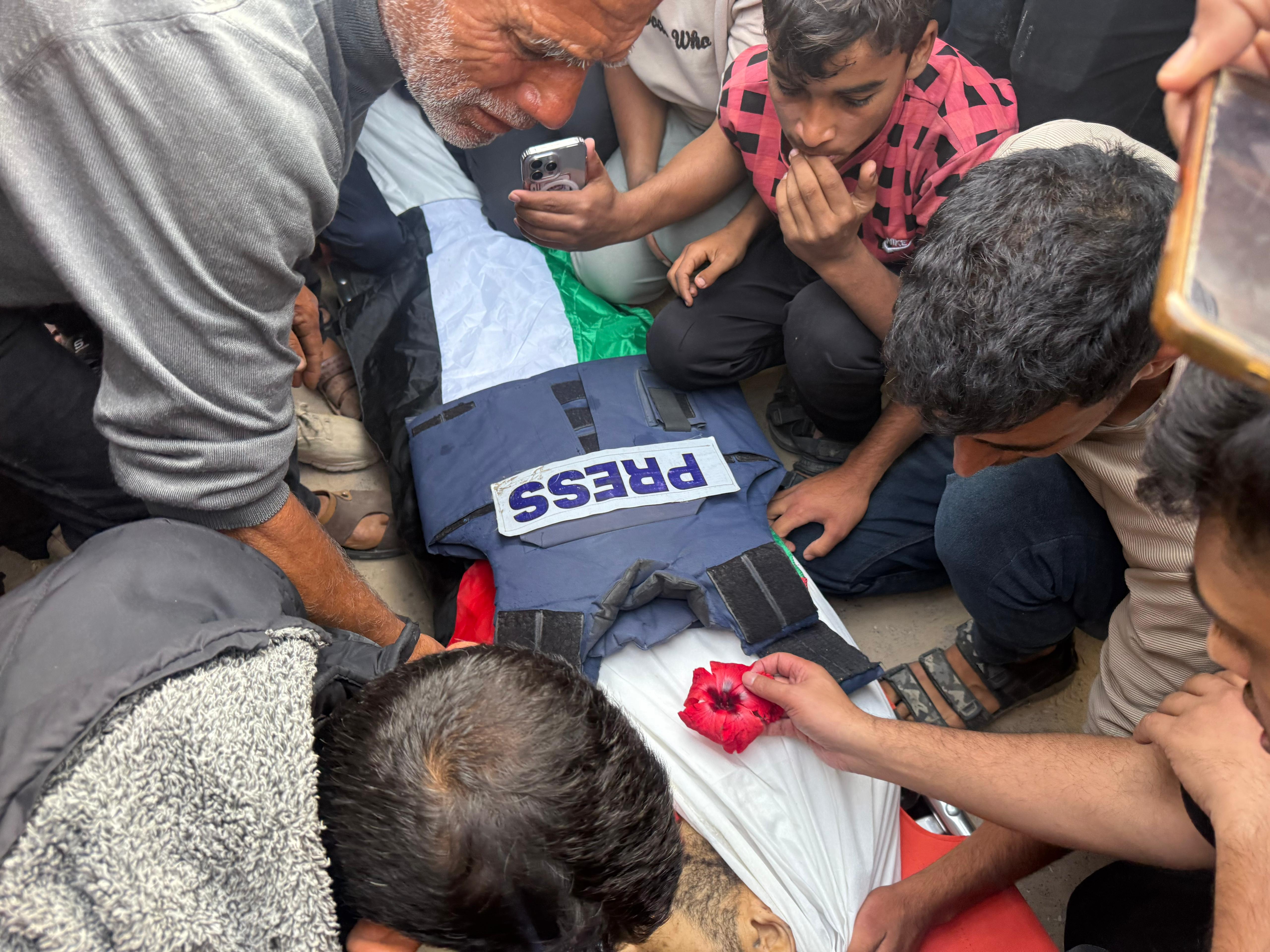 People mourn the loss of Palestinian journalist Hassan Eslaih, killed in an Israeli attack on Nasser Hospital, in Khan Yunis, Gaza on May 13, 2025.