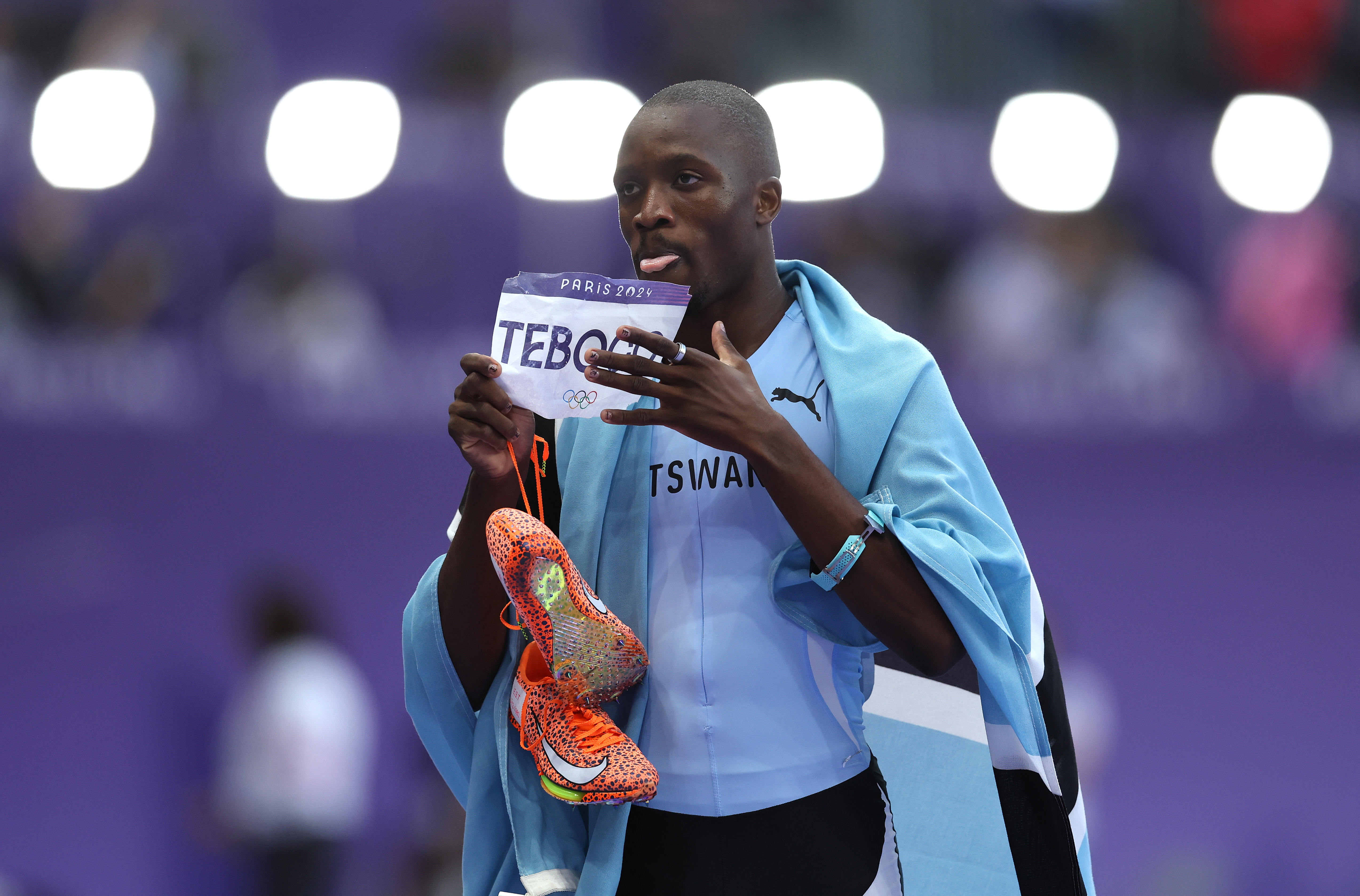 PARIS, FRANCE - AUGUST 08: Letsile Tebogo of Team Botswana celebrates winning the gold medal after competing in the Men's 200m Final on day thirteen of the Olympic Games Paris 2024 at Stade de France on August 08, 2024 in Paris, France. (Photo by Julian Finney/Getty Images)
