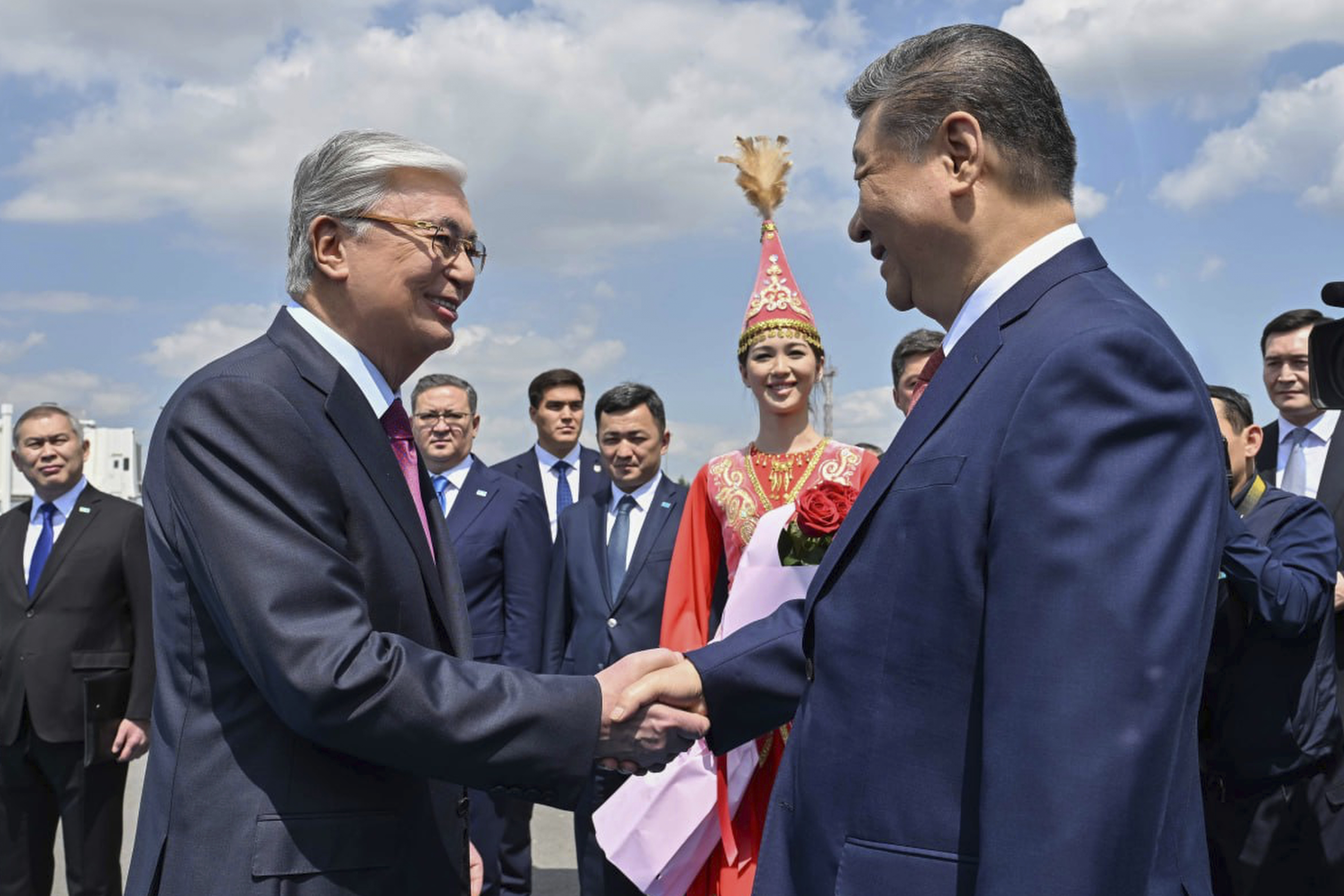 In this photo released by Kazakhstan's Presidential Press Office, Kazakh President Kassym-Jomart Tokayev, left, and Chinese President Xi Jinping shake hands at an international airport outside Astana, Kazakhstan, on Monday, June 16, 2025. (Kazakhstan's Presidential Press Office via AP)