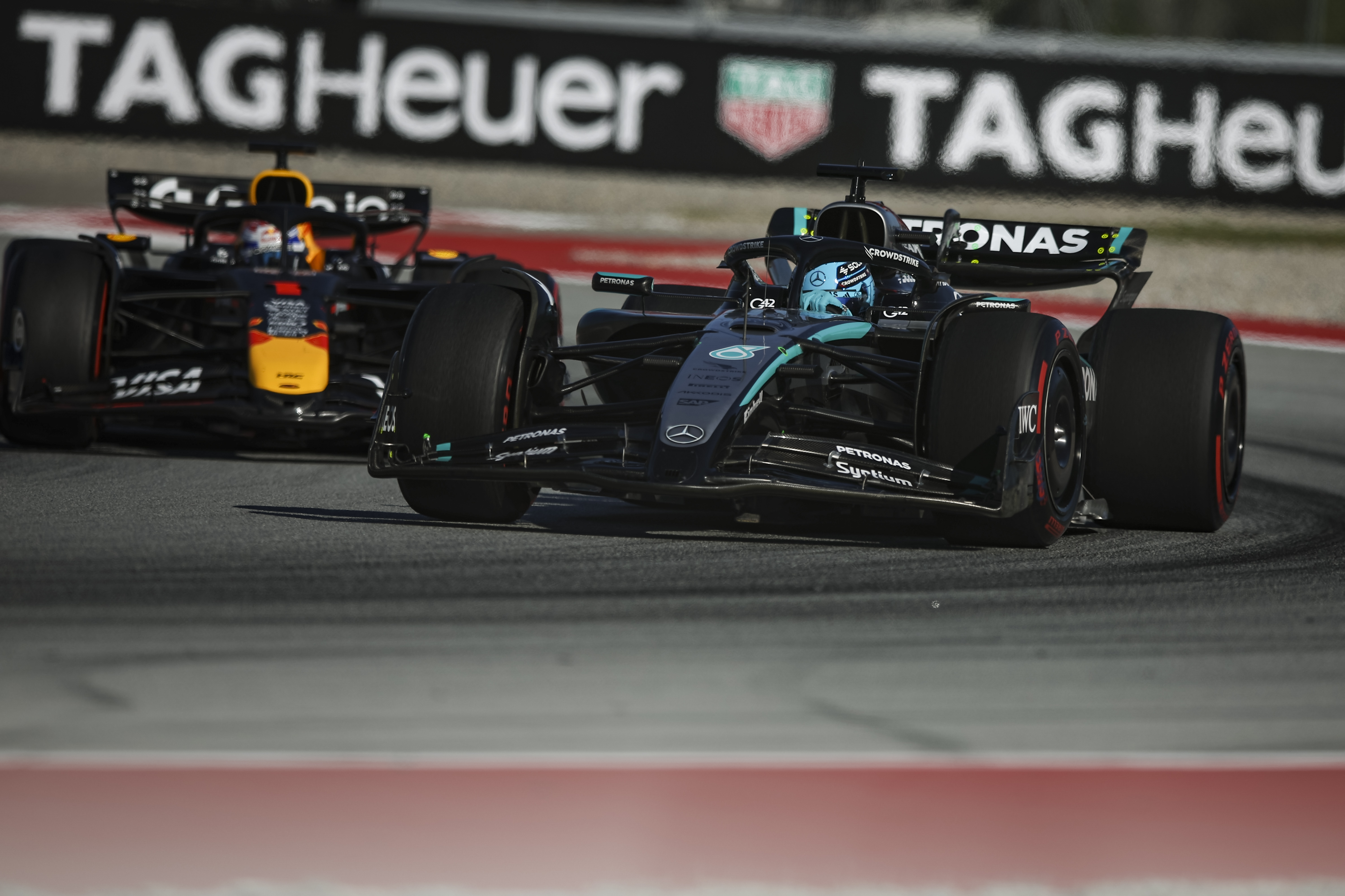 George Russell, right, of Mercedes and Max Verstappen of Red Bull Racing compete during the Spanish Grand Prix