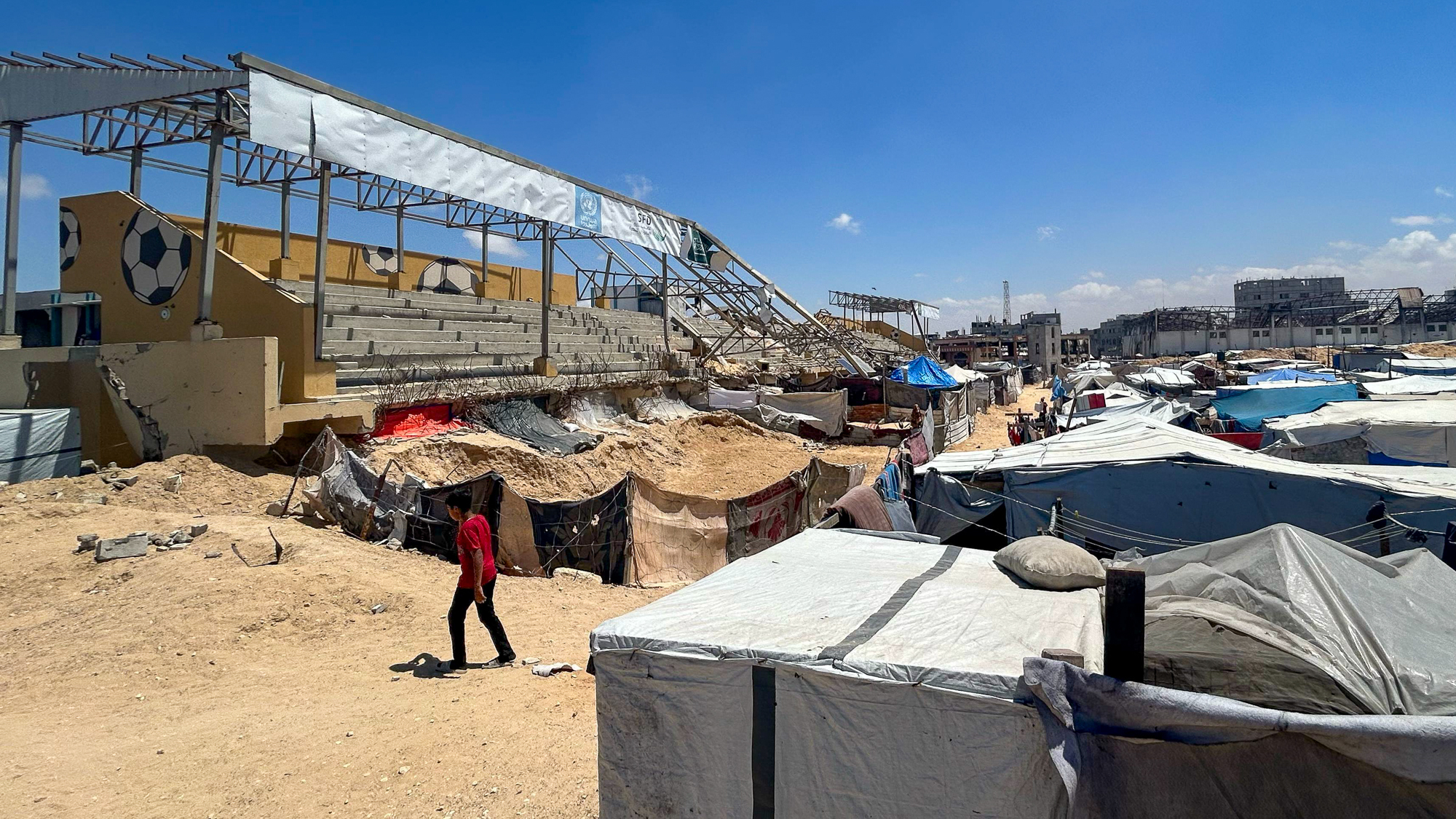 A lone grandstand remains partially intact in an otherwise completely destroyed Khan Younis football stadium. The venue, once a popular cultural and social hub of the Khan Younis sports community, has now become a shelter for thousands of internally displaced Gazans