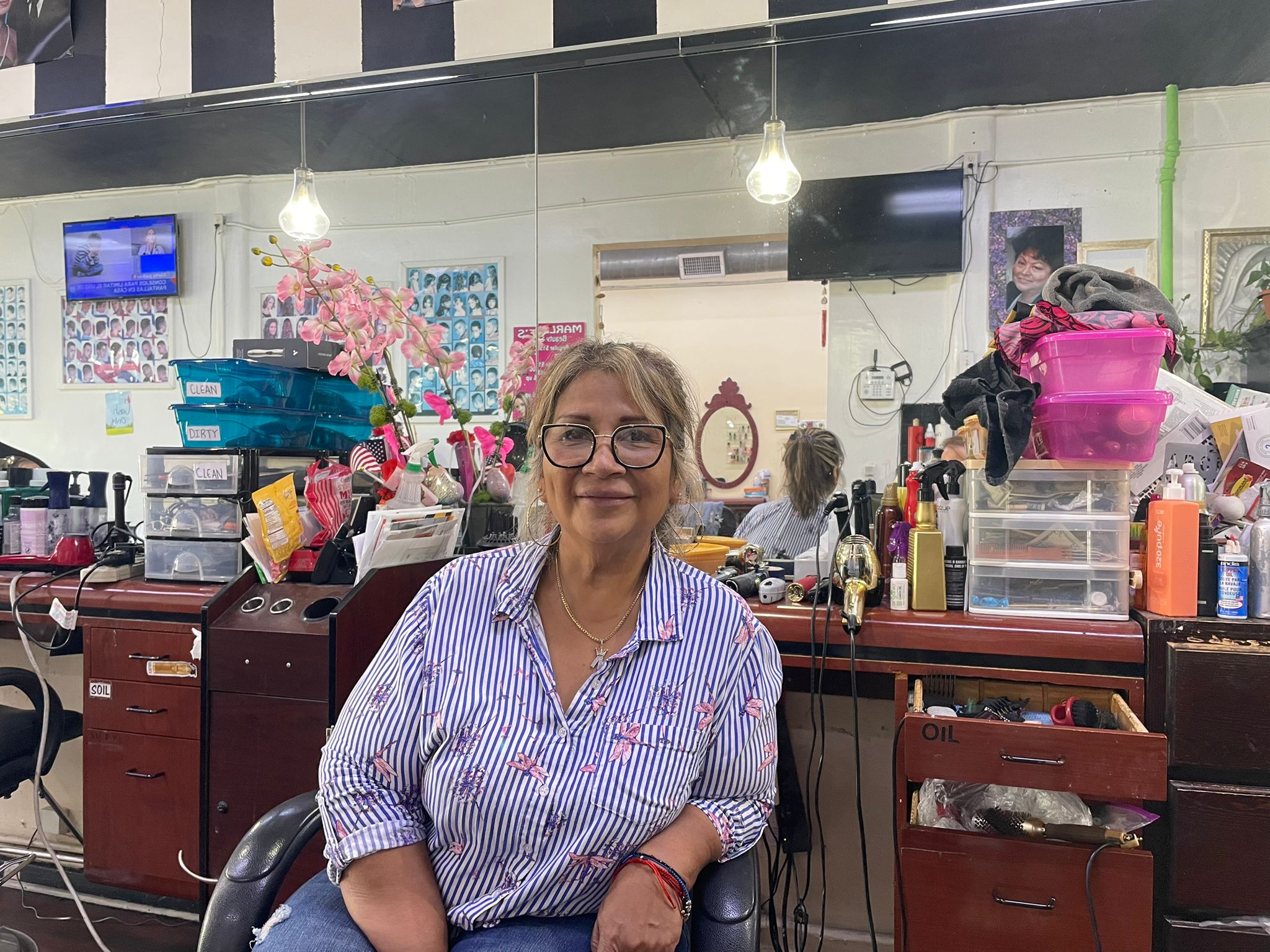 A woman sits in a hair salon