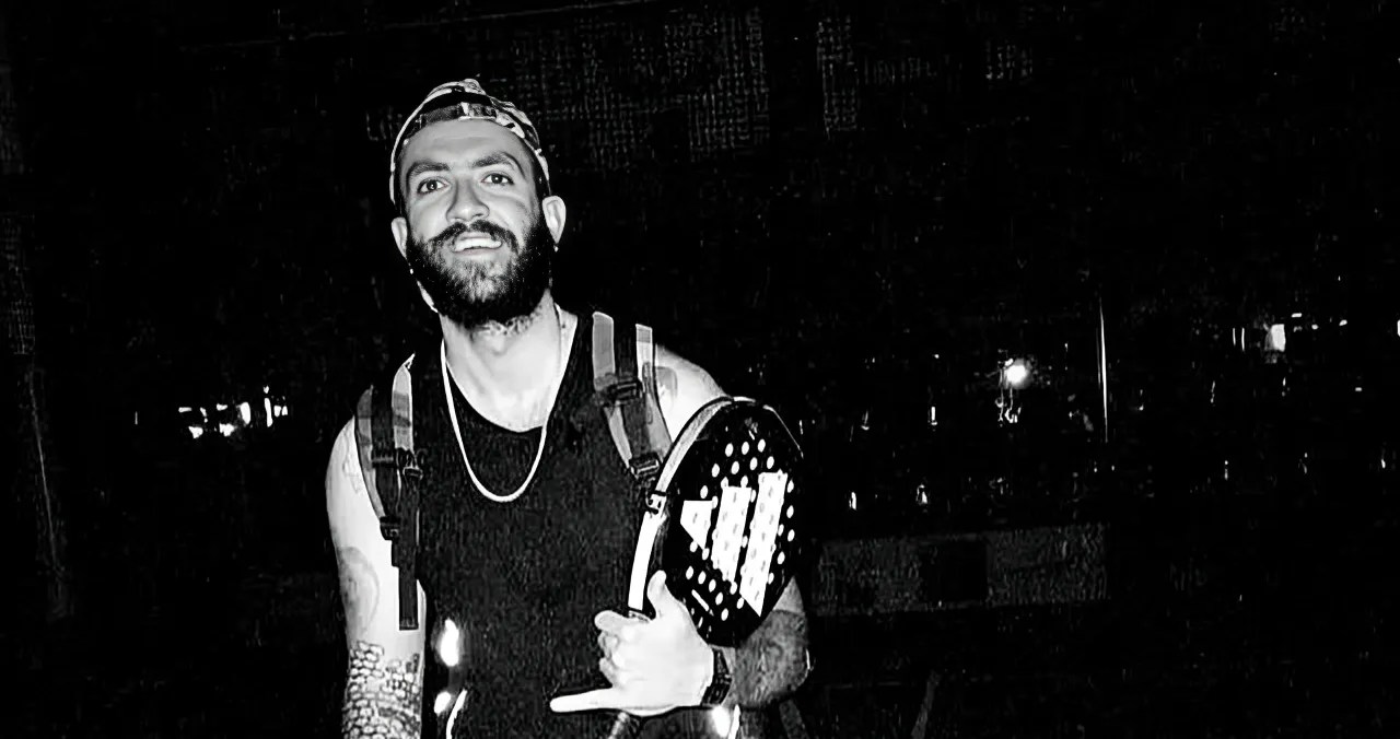 A black-and-white image of Parsa, a tennis player, holding a racket