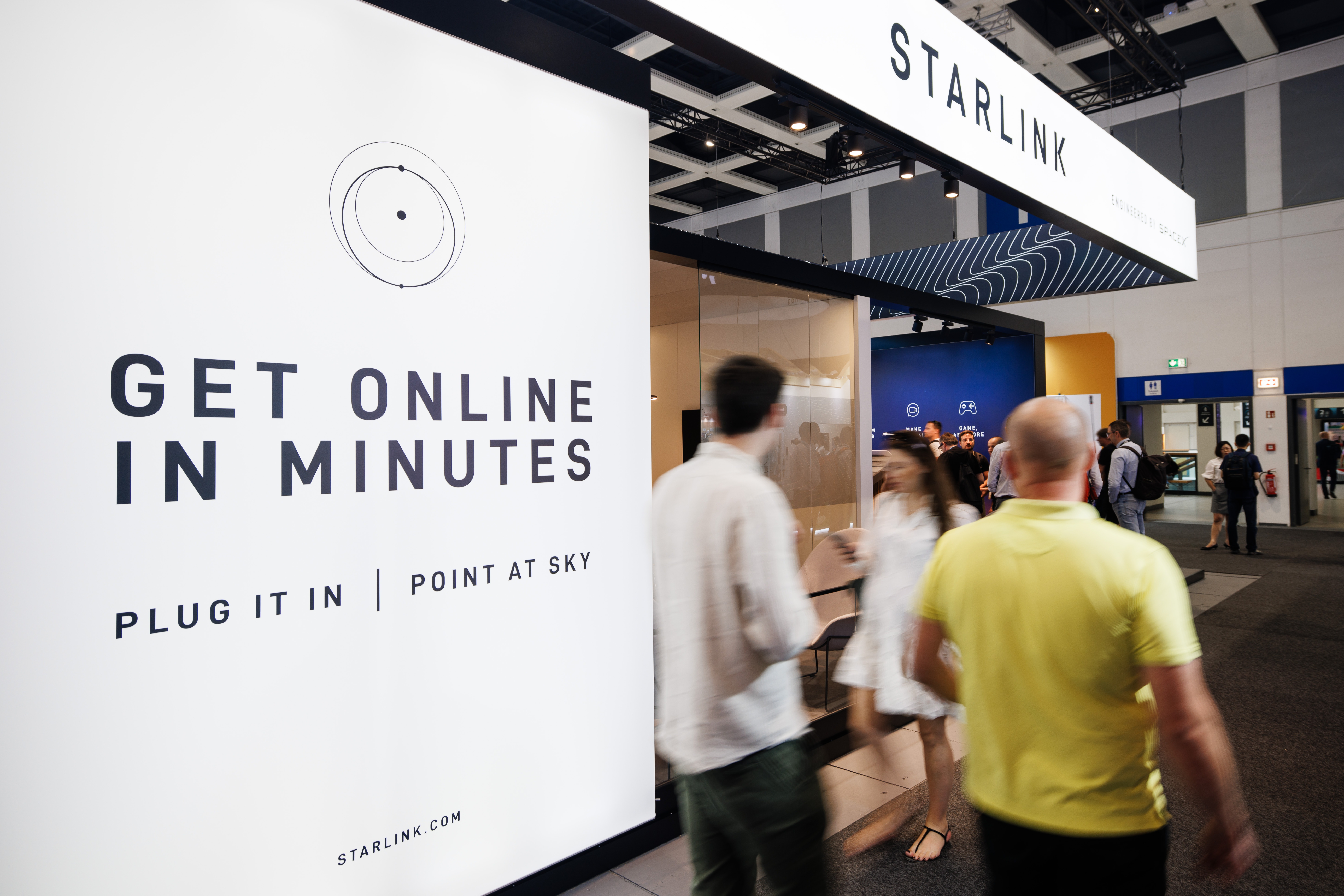epa11588980 Visitors pass by the booth of Starlink by SpaceX during the opening day of the 100th IFA trade fair in Berlin, Germany, 06 September 2024. The IFA, the world's largest trade show for consumer electronics and home appliances, celebrates its 100th anniversary and takes place from 06 to 10 September 2024. EPA/CLEMENS BILAN
