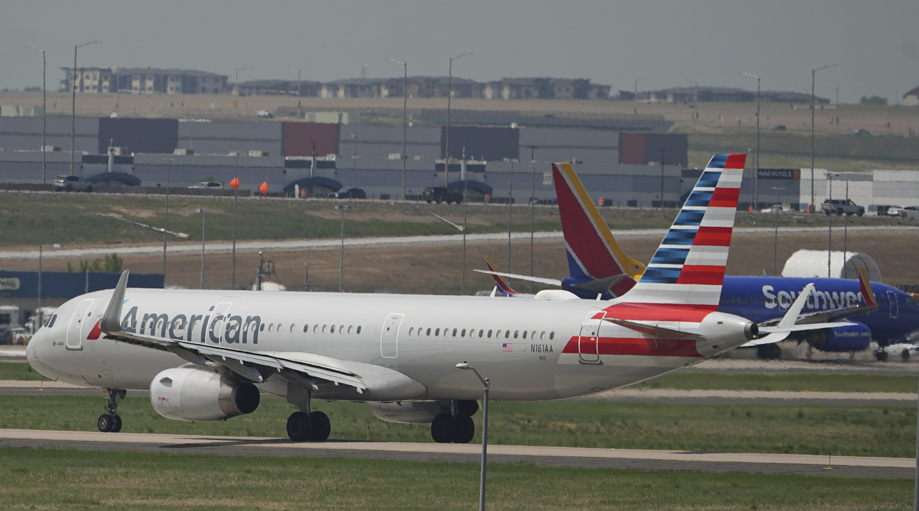 American Airlines jetliner taxis down a runway for departure from Denver International Airport Friday, May 23, 2025, in Denver. (AP Photo/David Zalubowski)