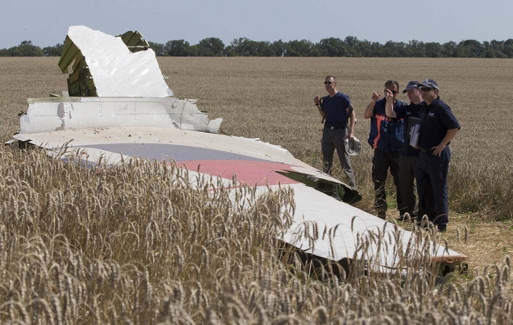 Australian and Dutch investigators examine a piece of the downed Malaysia Airlines Flight 17 