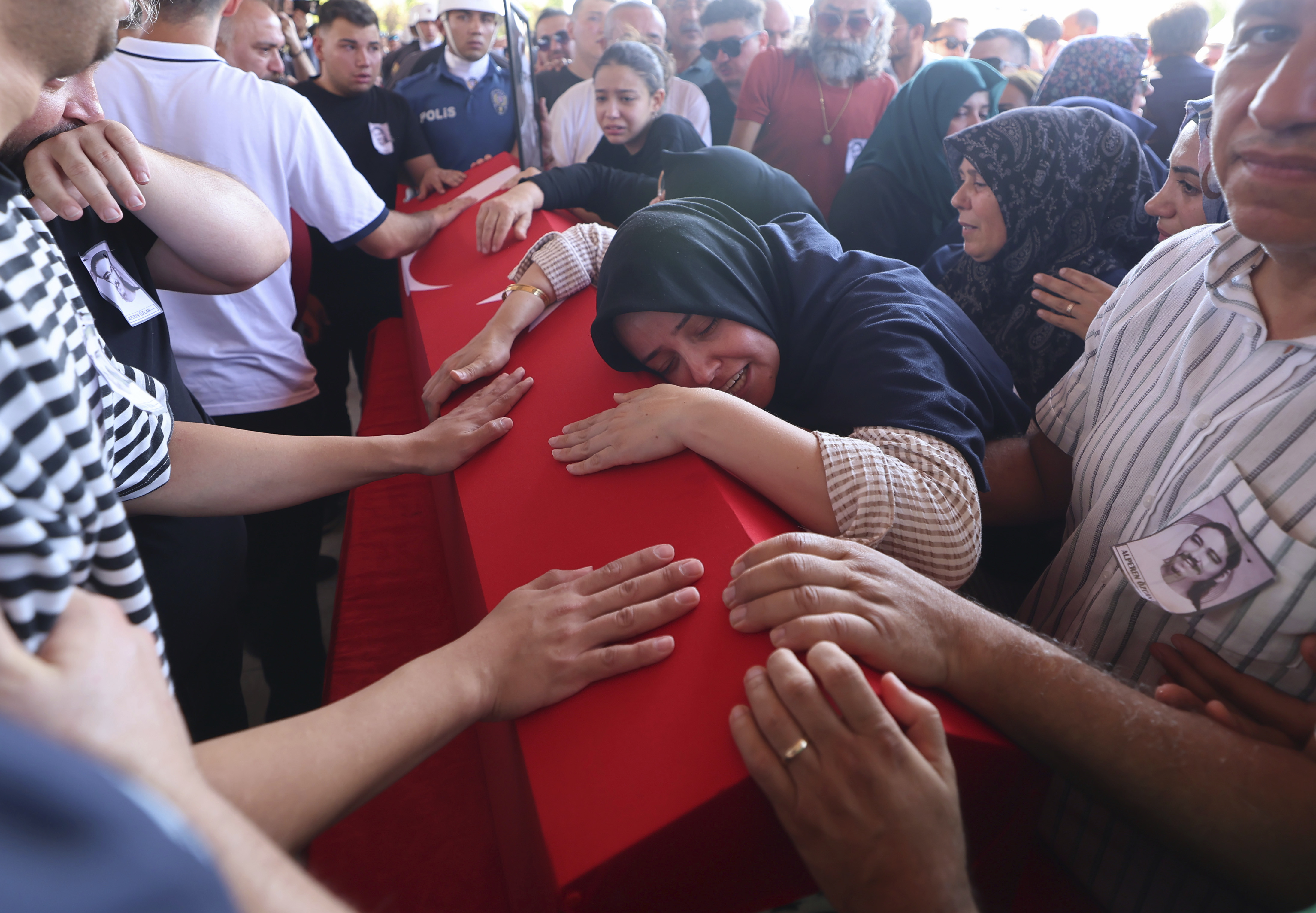 Relatives and friends mourn during the funeral of five rescue volunteers killed while battling a wildfire in northwestern Eskisehir province, in Ankara, Turkey, Thursday, July 24, 2025. (Yavuz Ozden/Dia Photo via AP)
