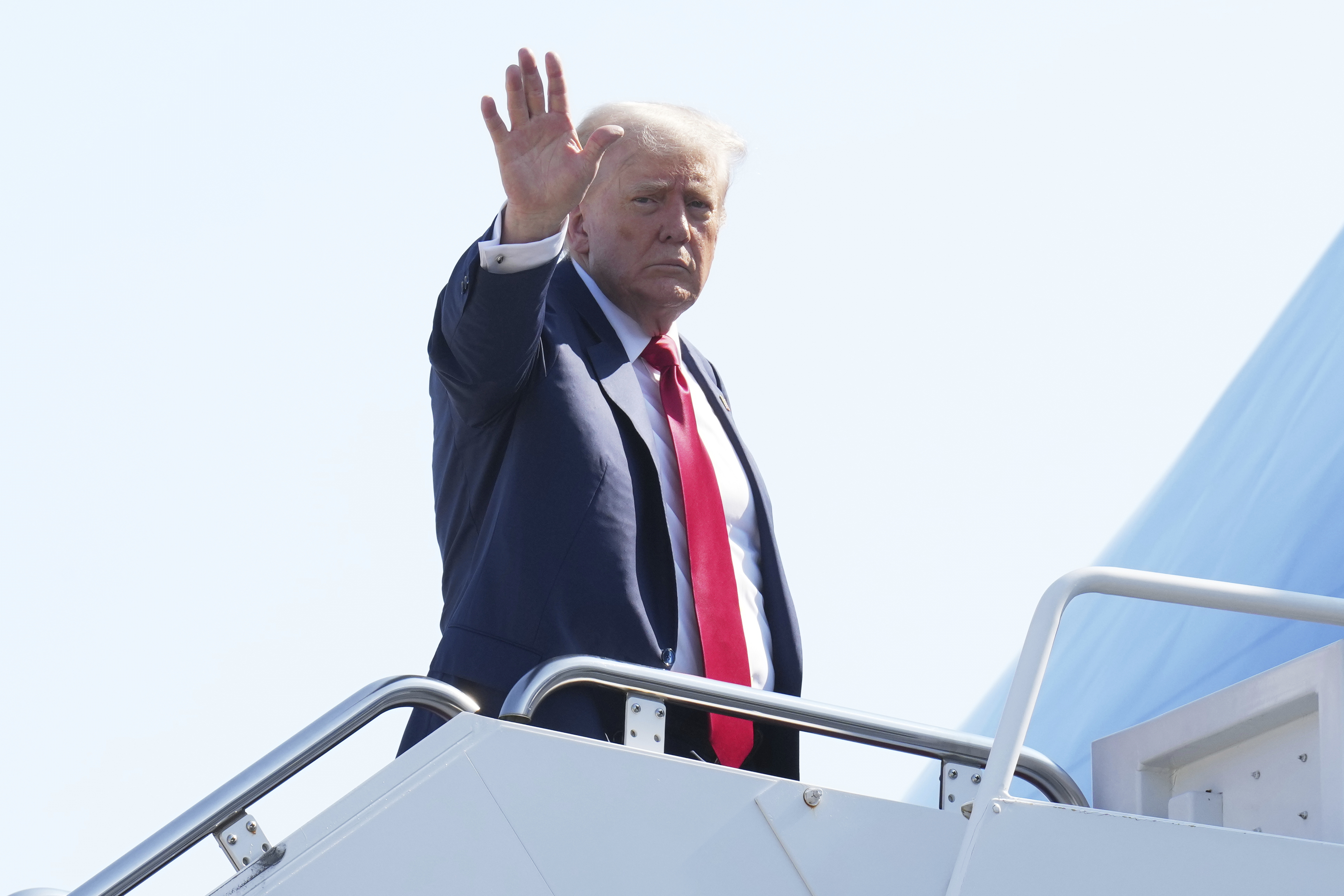 President Donald Trump waves as he boards Air Force One at Joint Base Andrews, Md., Friday, July 25, 2025, en route to Scotland. (AP Photo/Jacquelyn Martin)
