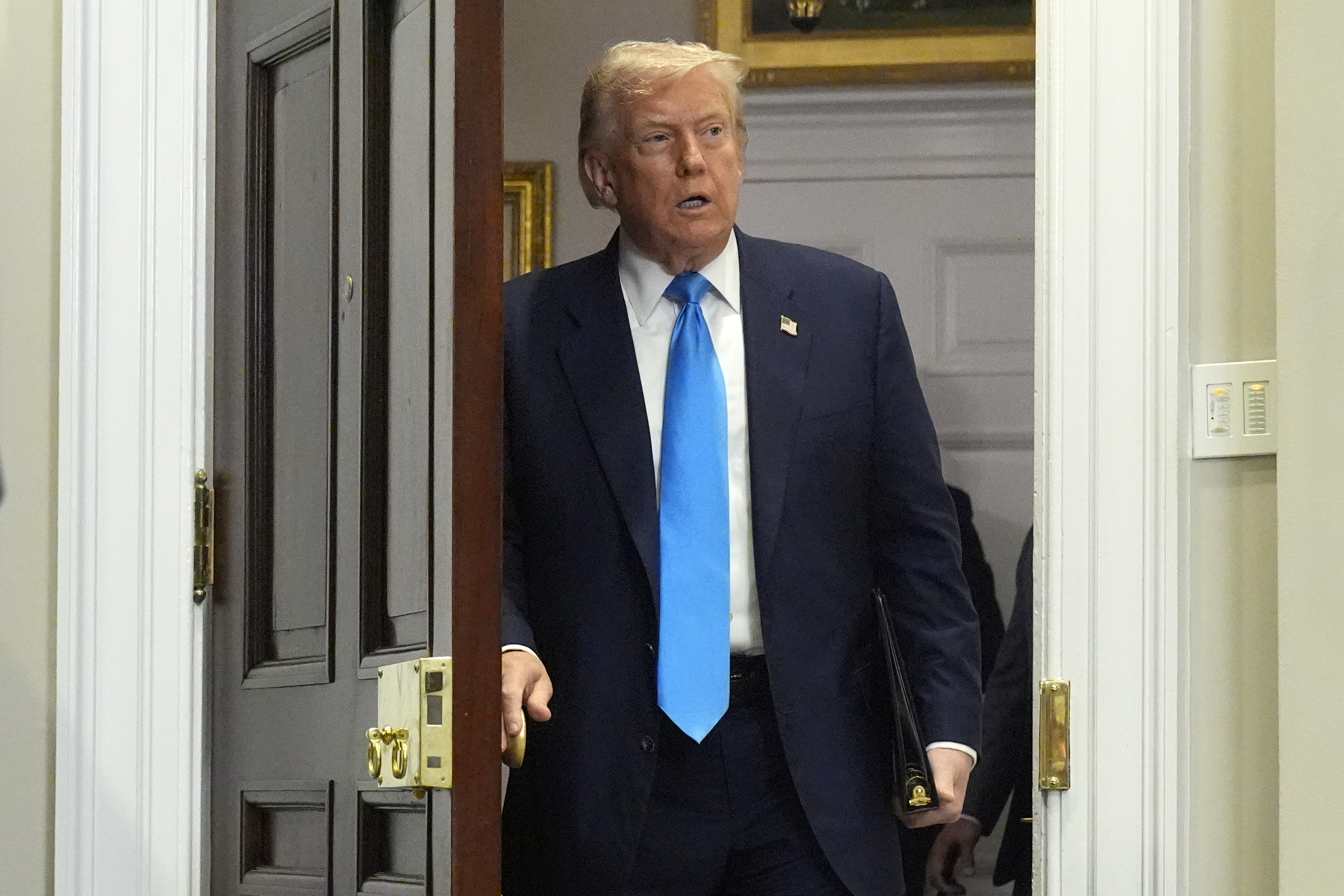 President Donald Trump arrives to sign the VA Home Loan Program Reform Act into law in the Roosevelt Room at the White House, Wednesday, July 30, 2025, in Washington. (AP Photo/Mark Schiefelbein)