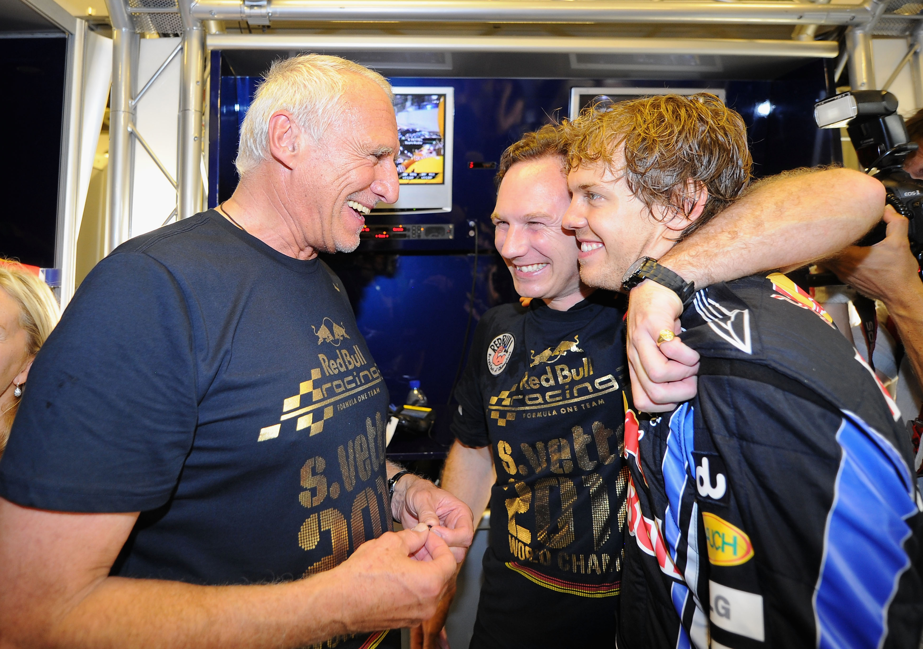 Horner, centre, celebrates Red Bulls’ first F1 Driver’s World Championship with Red Bull Racing team owner Dietrich Mateschitz, left, and F1 team driver Sebastian Vettel, right, on November 14, 2010, in Abu Dhabi, United Arab Emirates