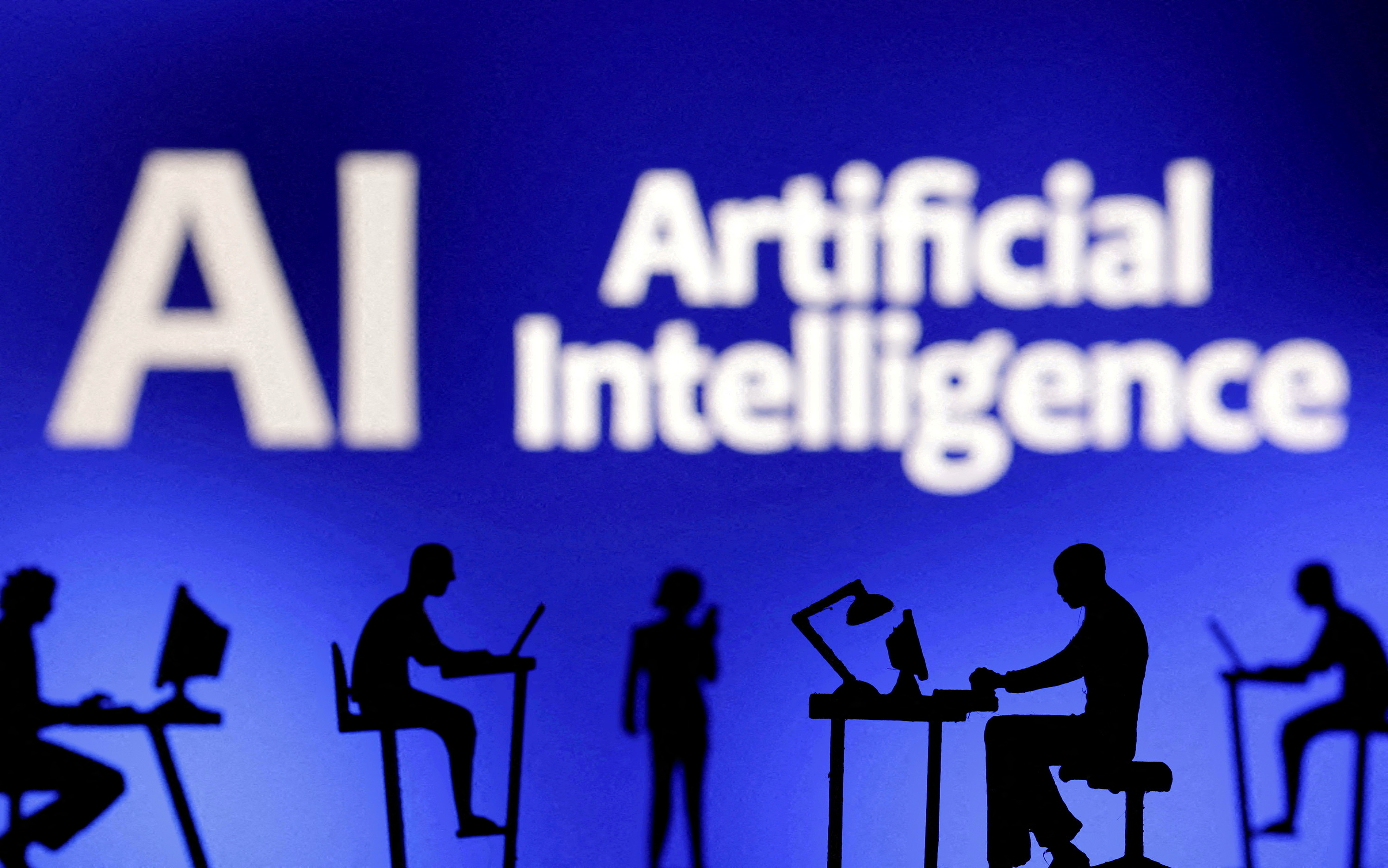 FILE PHOTO: Figurines with computers and smartphones are seen in front of the words "Artificial Intelligence AI" in this illustration created on February 19, 2024. REUTERS/Dado Ruvic/Illustration/File Photo