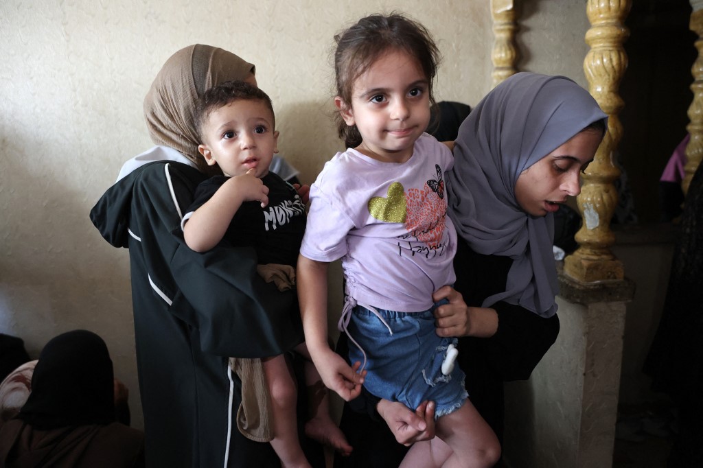 Relatives of Al Jazeera correspondent Anas al-Sharif, carry his 15-month-old son Salah (L) and 4-year-old daughter Sham (R) during his funeral in Gaza City on August 11, 2025. [Omar Al-Qattaa/AFP]