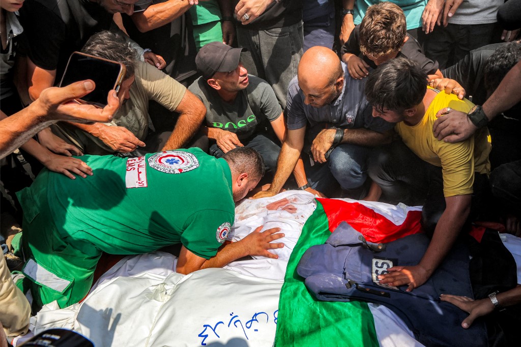 Mourners bid farewell to the bodies of the Al Jazeera journalists who were killed in an overnight Israeli strike on their tent in Gaza City, before their burial at the Sheikh Radwan cemetery in Gaza City on August 11, 2025. [Omar AL-Qattaa/AFP]