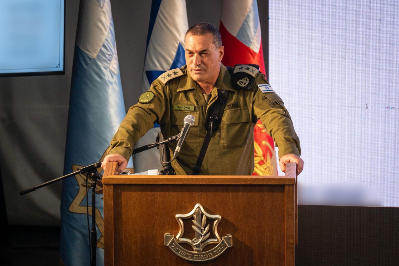 Eyal Zamir speaks at a podium.