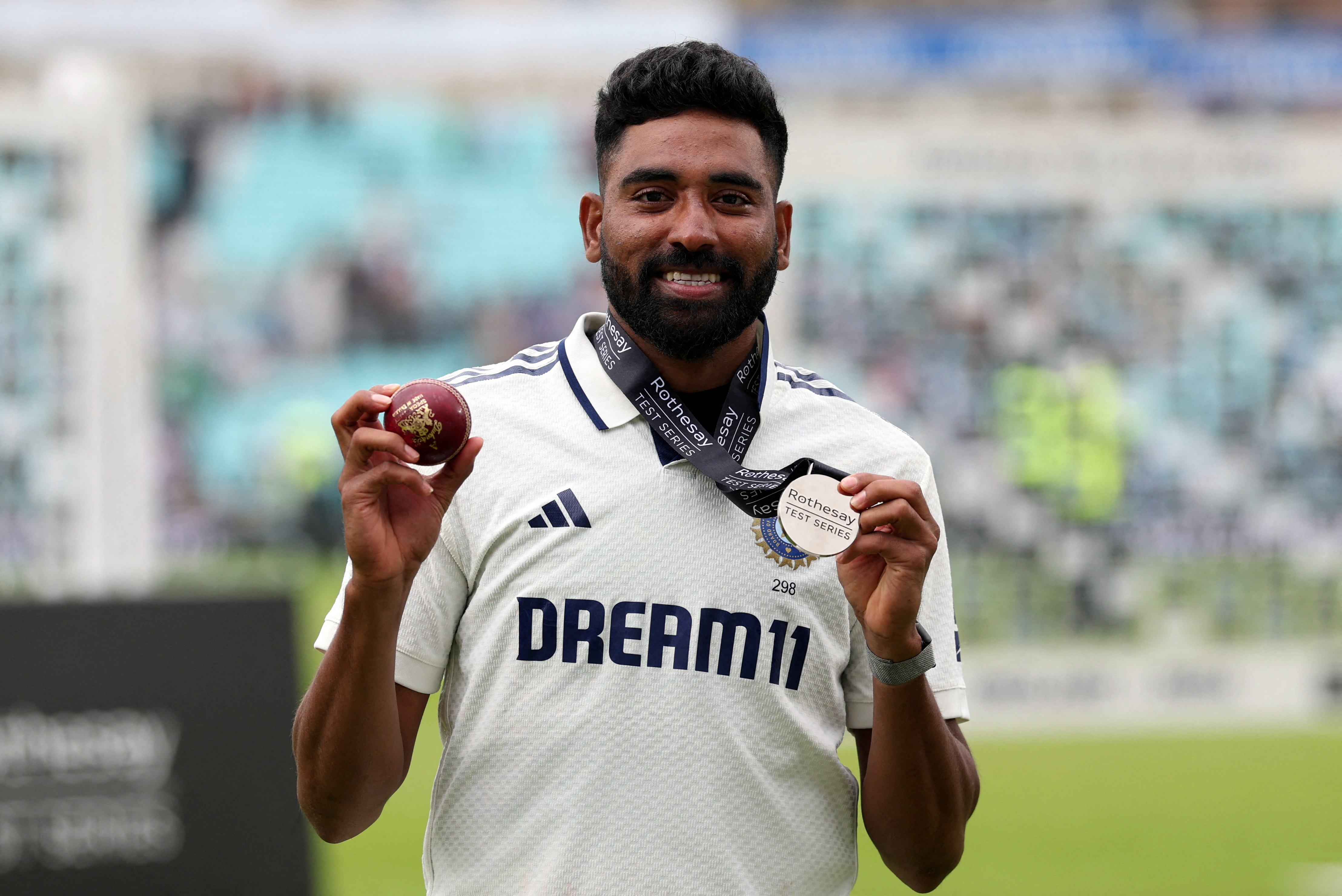 India's Mohammed Siraj poses after winning the player of the match award after India won the match to draw the test series