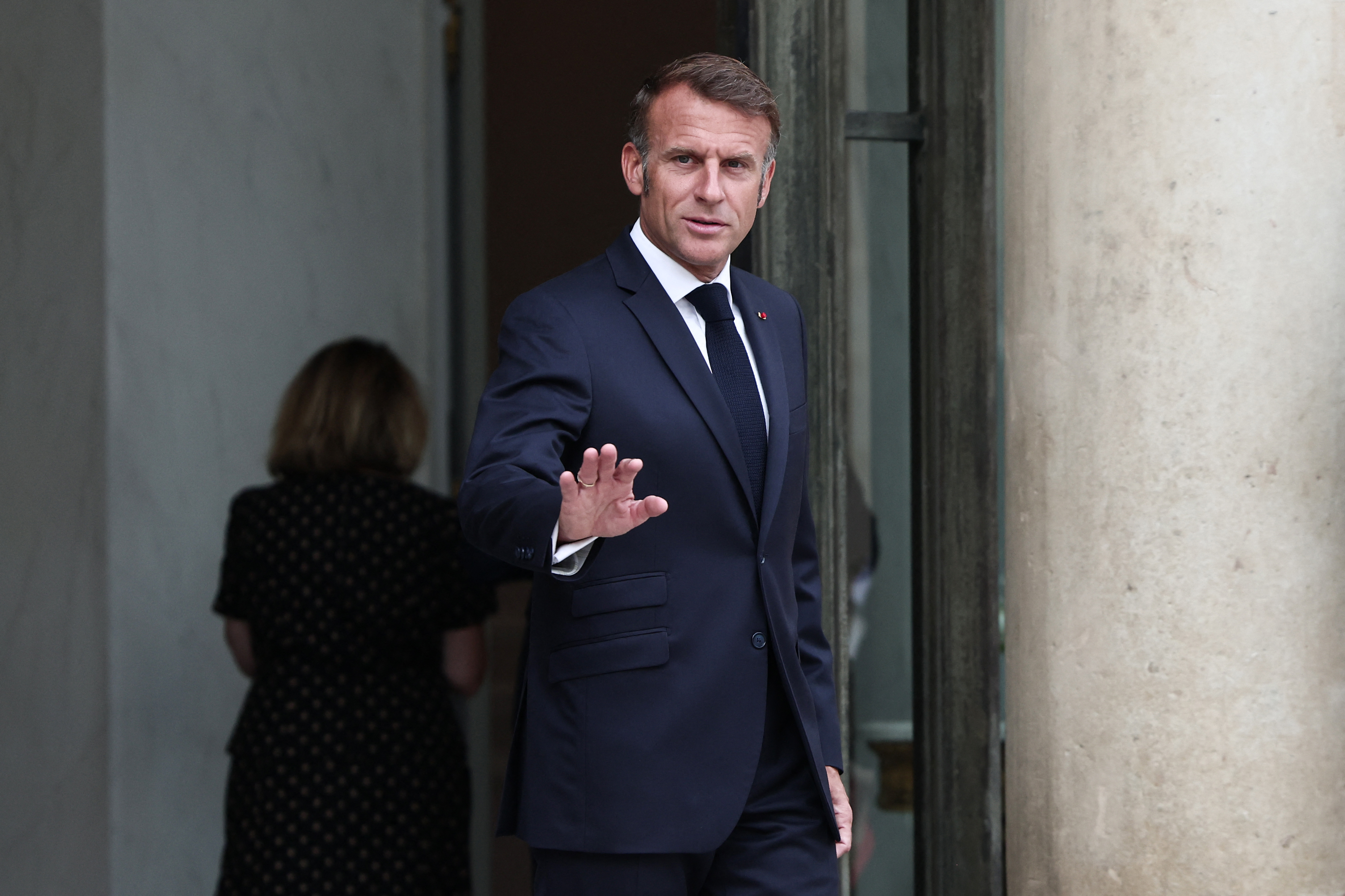 France's President Emmanuel Macron waves as he arrives to welcome Senegalese President for a meeting at the Elysee Presidential Palace in Paris on August 27, 2025.