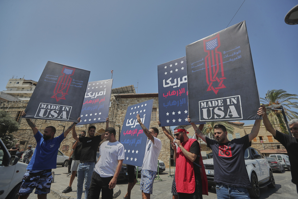 Hezbollah supporters holding signs