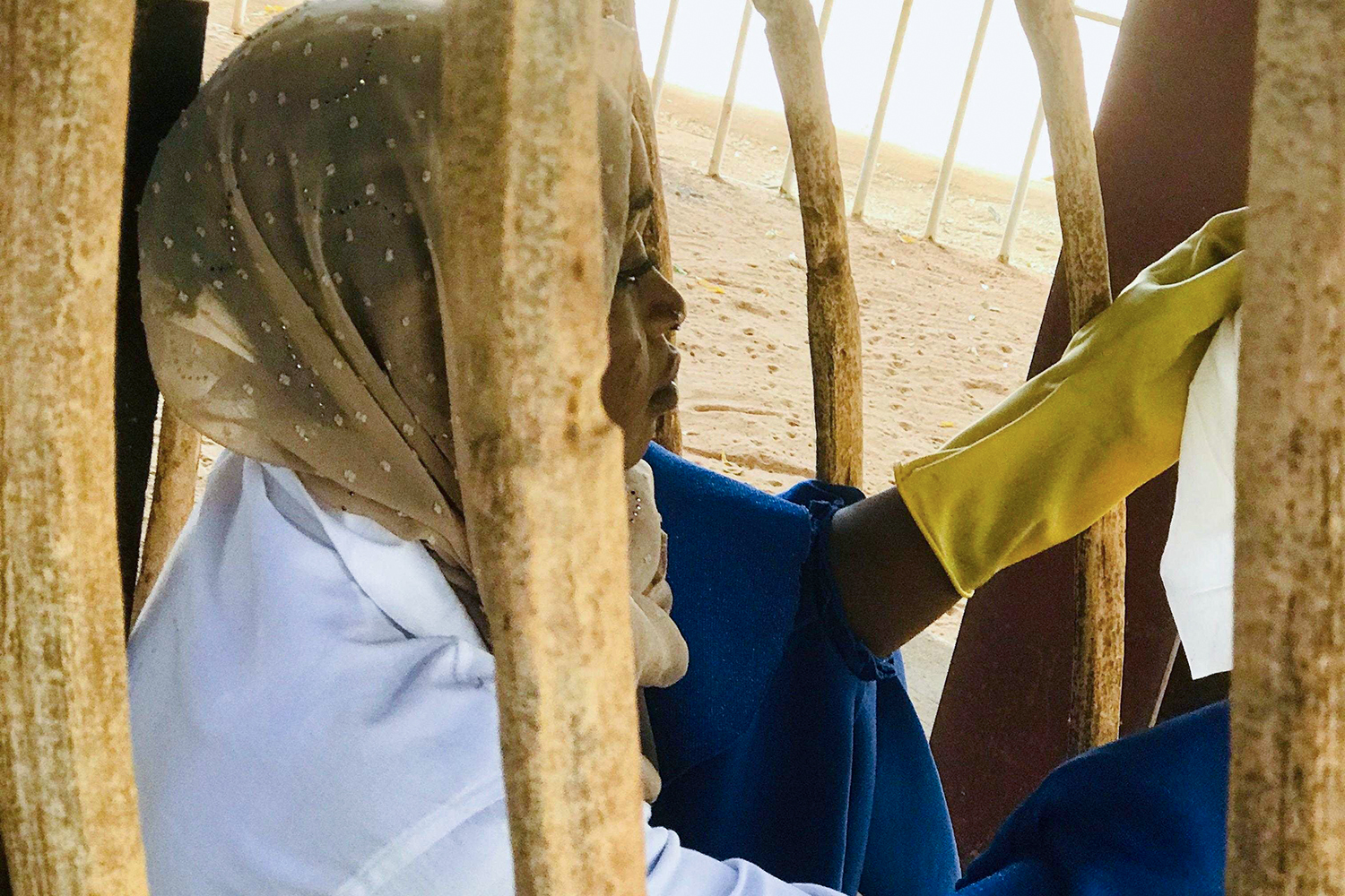 Rachidatou Hassane, an intern at Niamey museum, cleans fossils on display