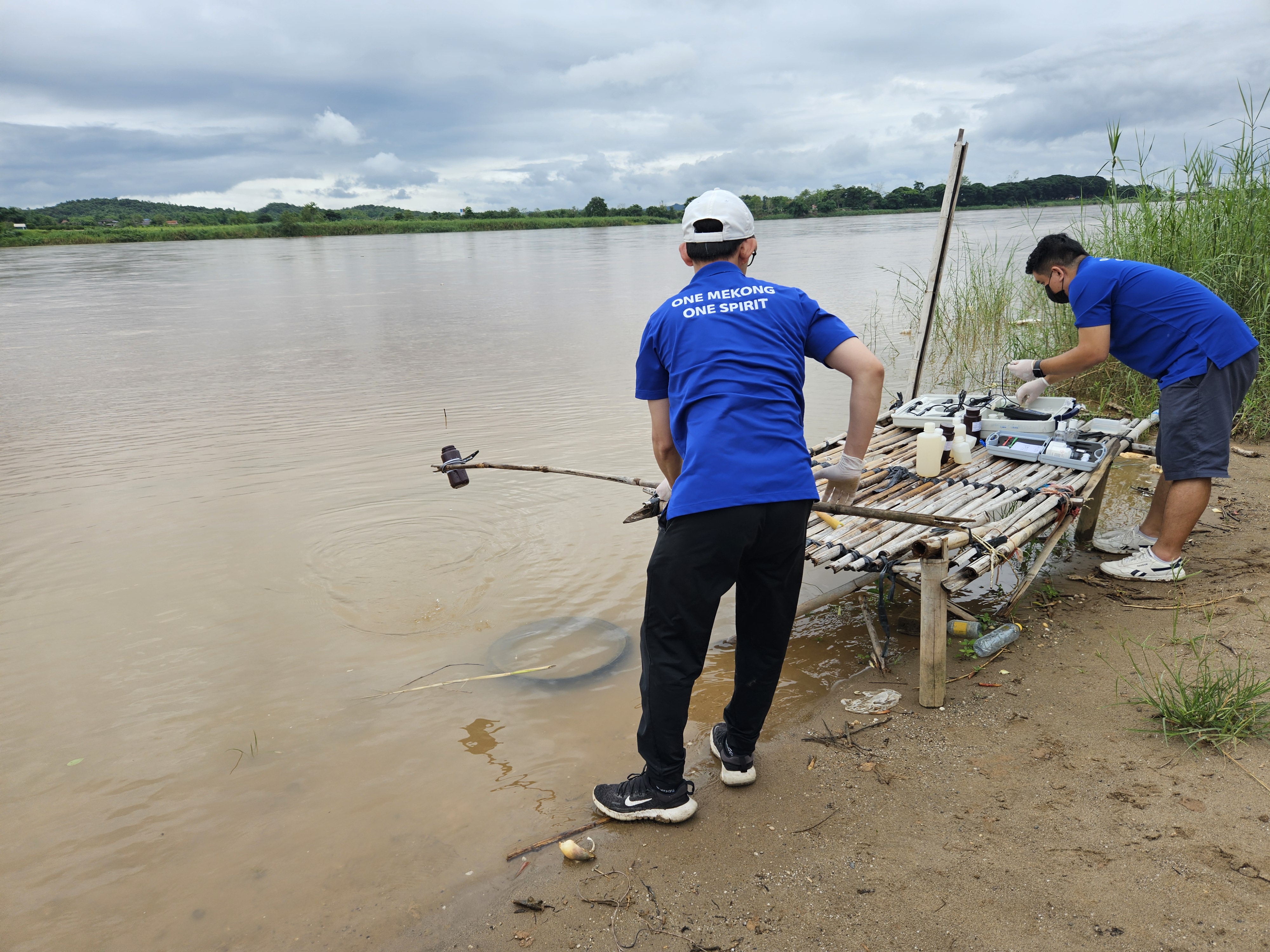 Mekong River Commission staff take a water sample for testing from the Mekong River along the Thai-Laos border on June 10, 2025. (Mekong River Commission)