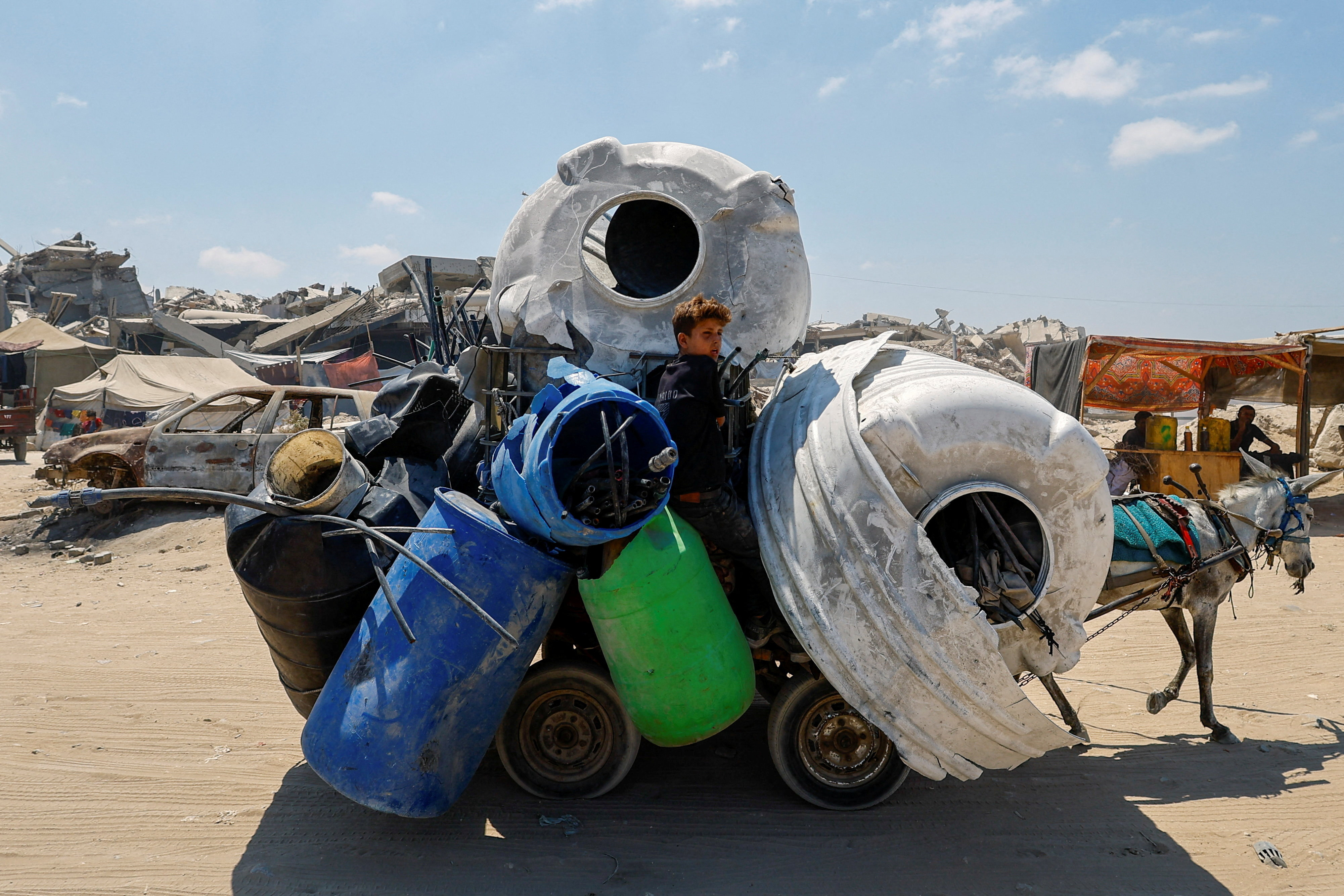 A Palestinian boy travels in a donkey-drawn cart as the Israeli military prepares to relocate residents to seize Gaza City