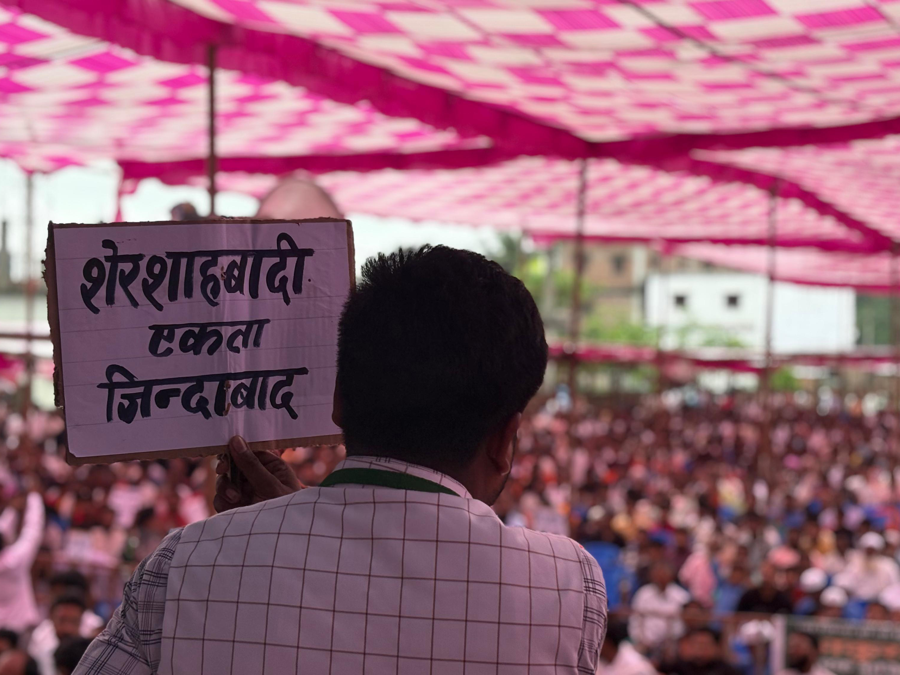 Mukhtar Alam holds a sign during a recent protest.