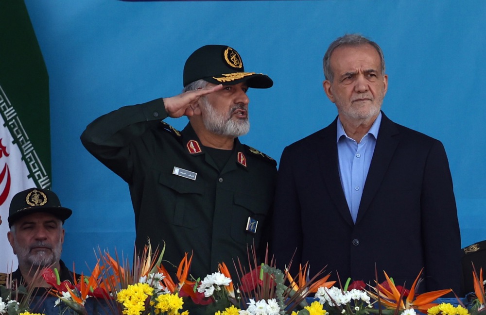 epa12173169 (FILE) - Iranian President Masoud Pezeshkian (R) and Commander of the Islamic Revolutionary Guard Corps' Aerospace Force Amir Ali Hajizadeh (C) attend the annual military parade marking the Iraqi invasion in 1980, in Tehran, Iran, 21 September 2024 (reissued 13 June 2025). Israel launched strikes on Iran early 13 June, killing top military figures including Chairman of the Chiefs of Staff of Iran’s Armed Forces Major General Mohammad Bagheri, Chief Commander of the Islamic Revolutionary Guard Corps (IRGC) Major General Hossein Salami, Commander of Khatam al-Anbia Headquarters Major General Gholam Ali Rashid, and Amir Ali Hajizadeh, both countries confirmed. The strikes were part of Operation Rising Lion, Israel's Prime Minister Benjamin Netanyahu said, adding that Iran’s nuclear programme poses a threat to "Israel's very survival". EPA/ABEDIN TAHERKENAREH *** Local Caption *** 55758524 ID: 13122389 Size: 1730px x 1123px File size: 0.4MB Publishing Time: Fri, 13 Jun 2025 12:31:55 GMT