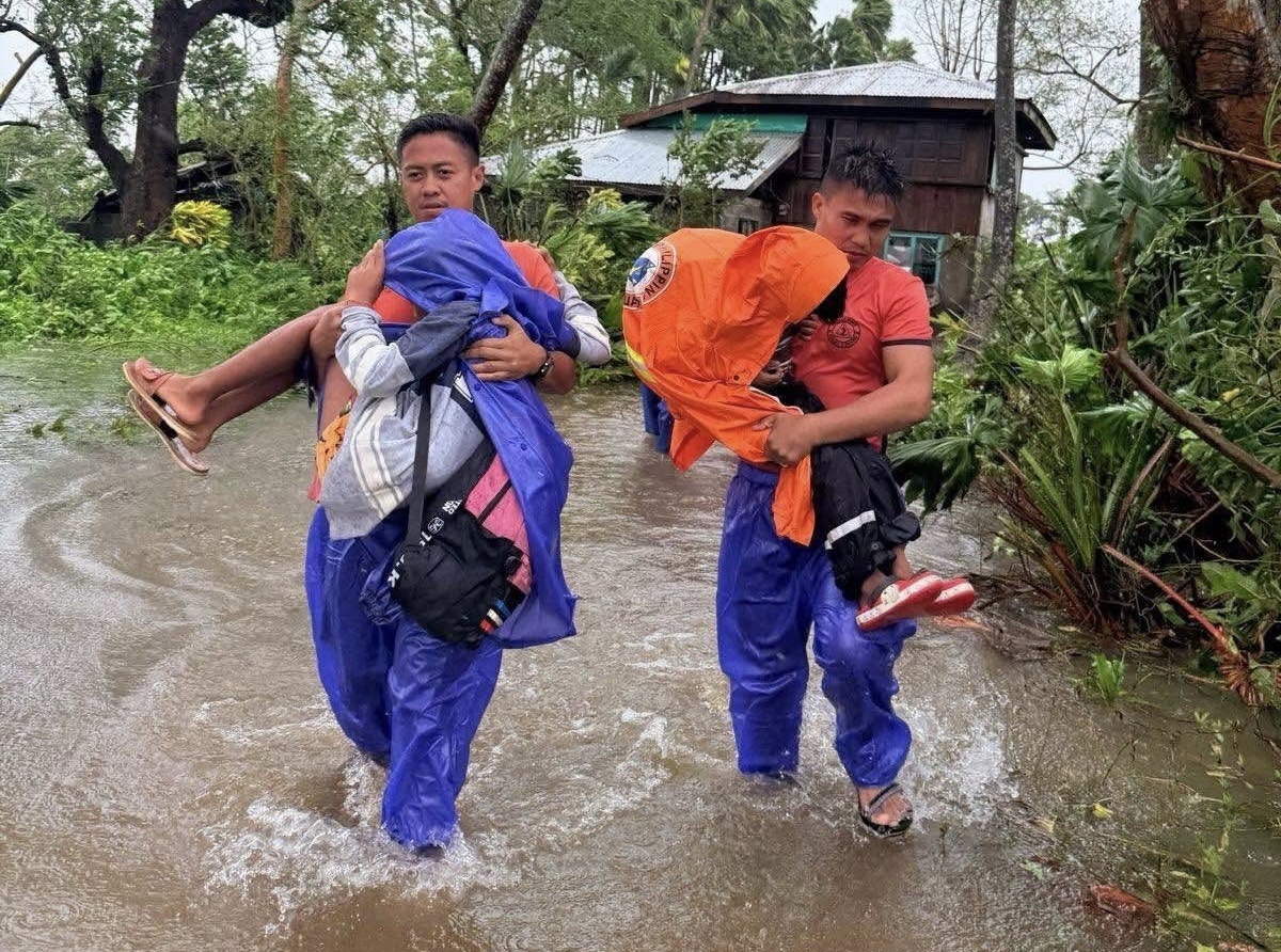 Coastguard personnel carry victims during a rescue mission.